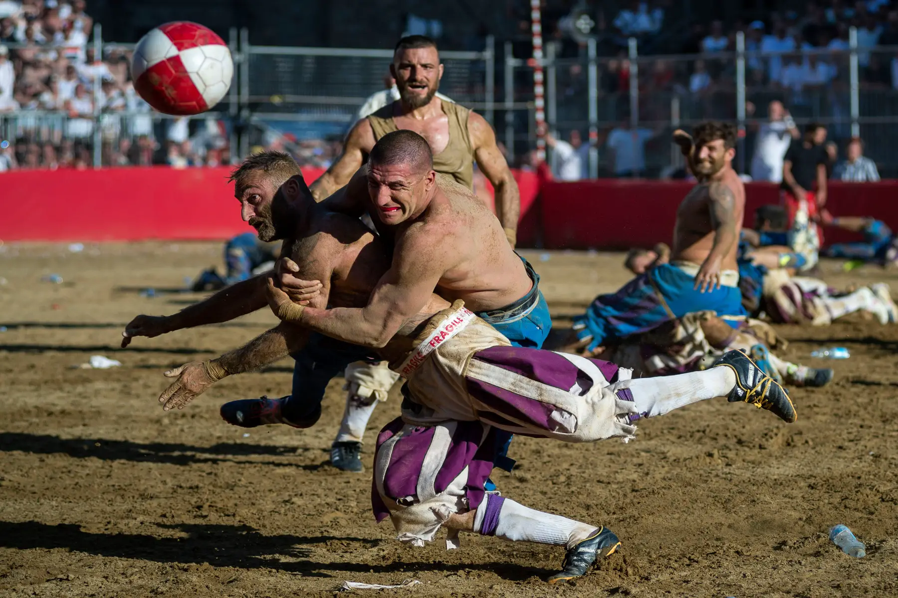 Players tackling each other at the Calcio Storico Fiorentino ancient football games