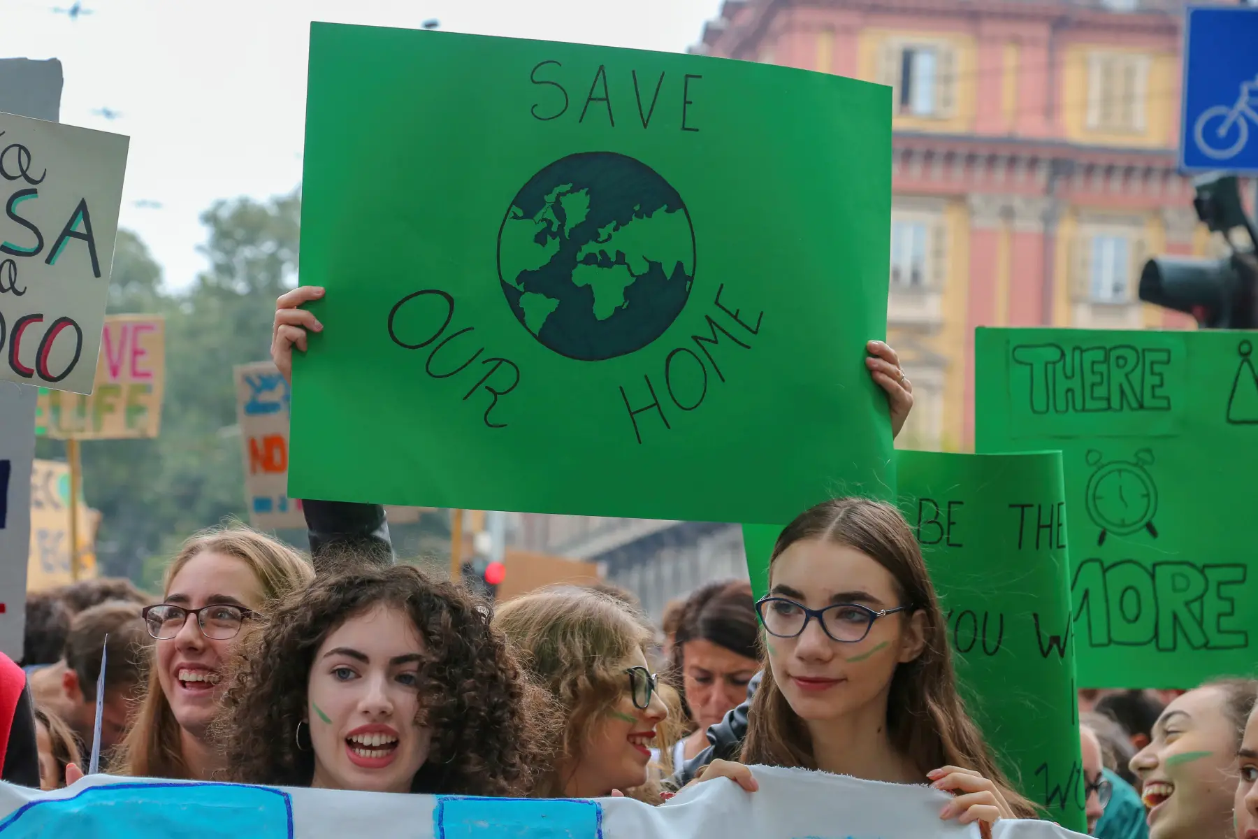 Two teenagers at the 2019 Fridays For Future Climate protest in Torino ( Italy), holding a sign that says 