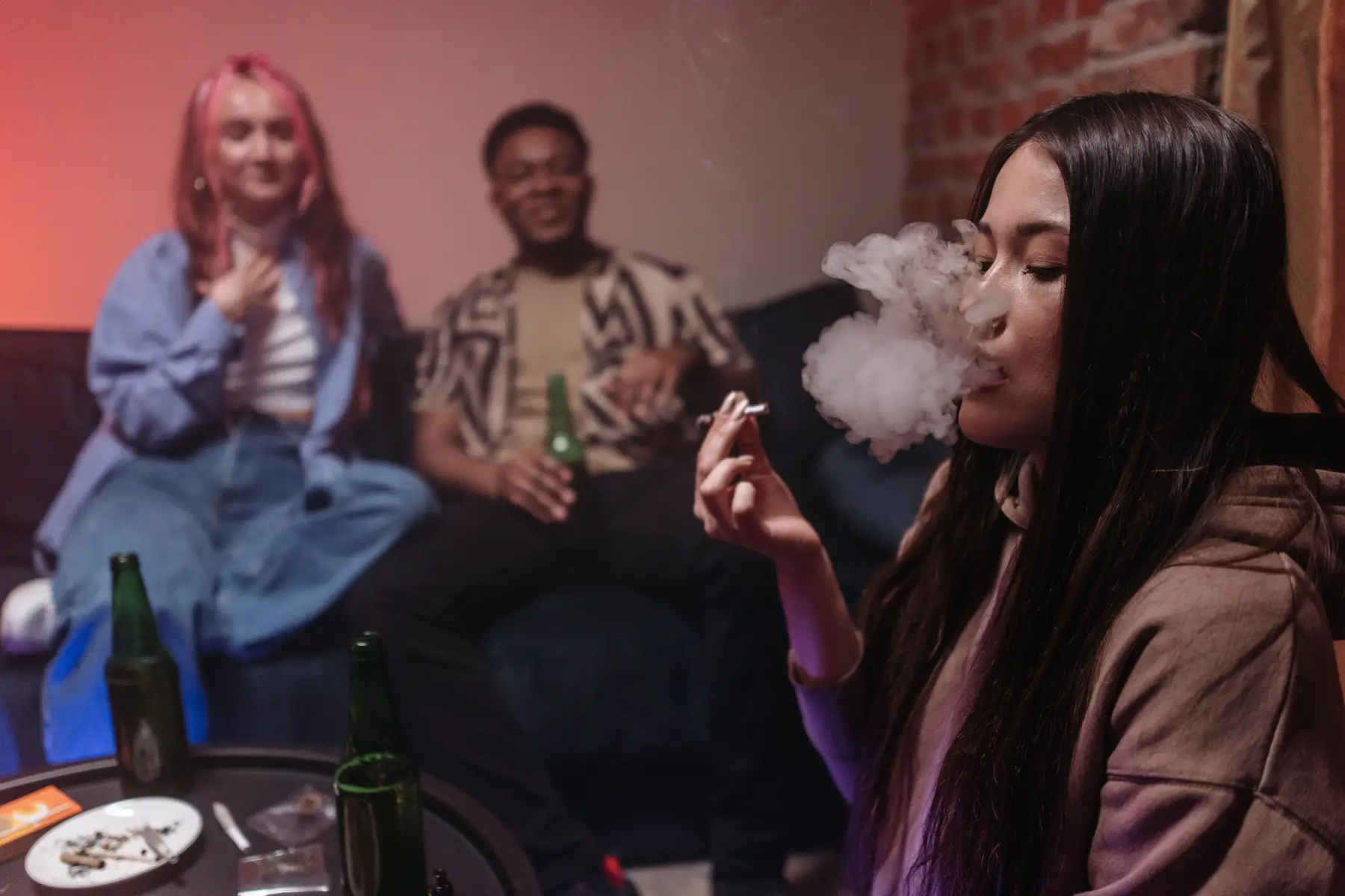Group of young friends smoking cannabis and drinking beer