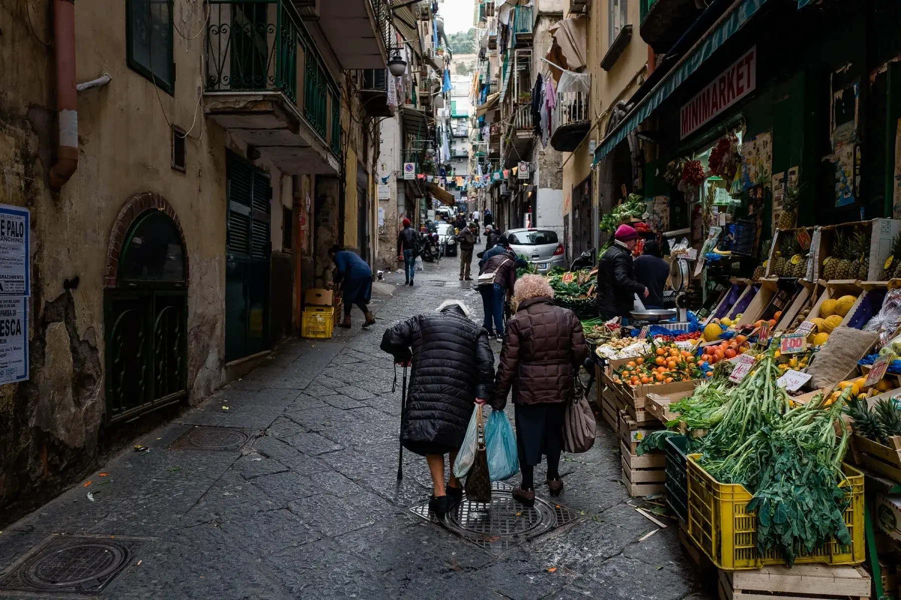 Elderly women walking up a street in Naples