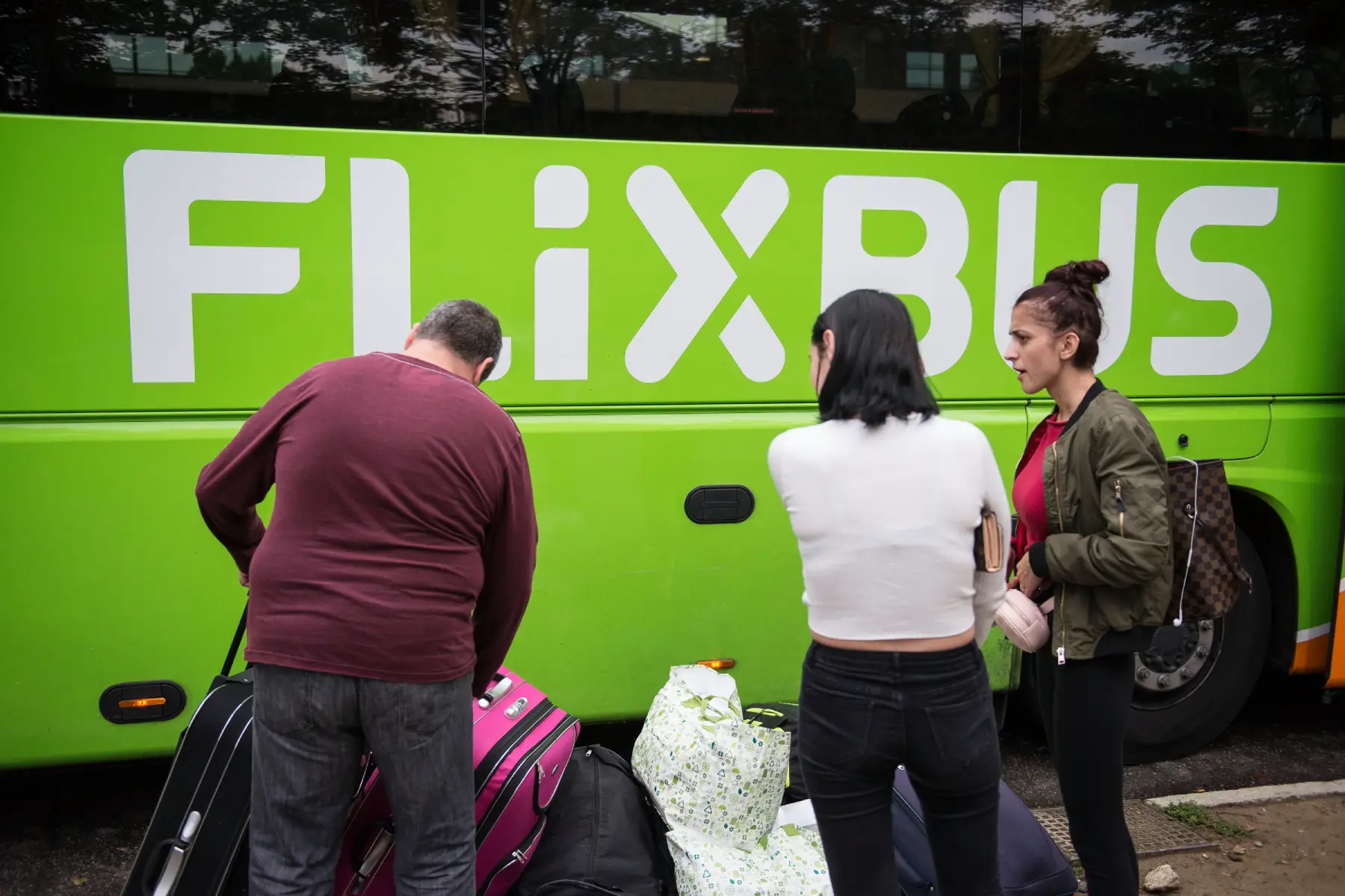 Passengers with luggage waiting to board a Flixbus in Torino