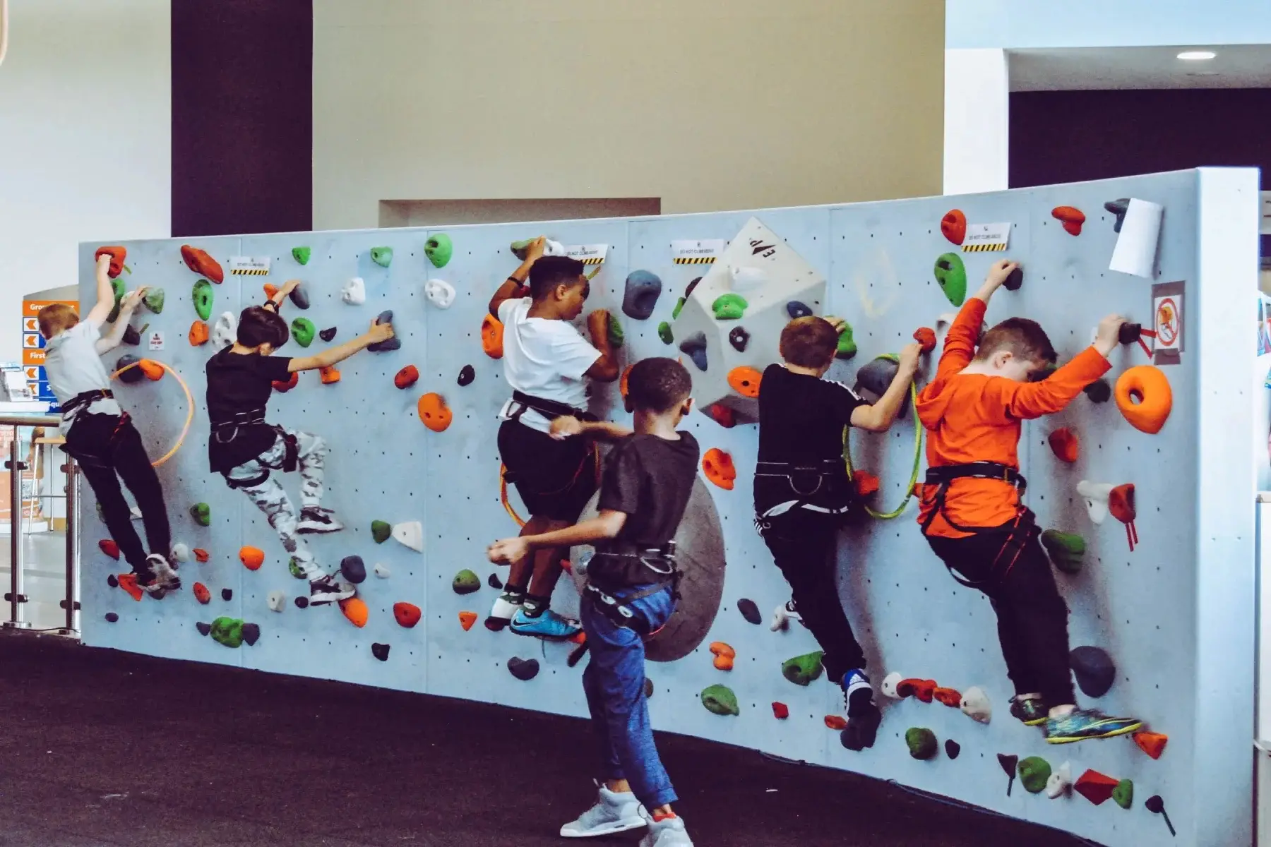 Group of young boys attending an indoor climbing club as an extracurricular activity outside of school