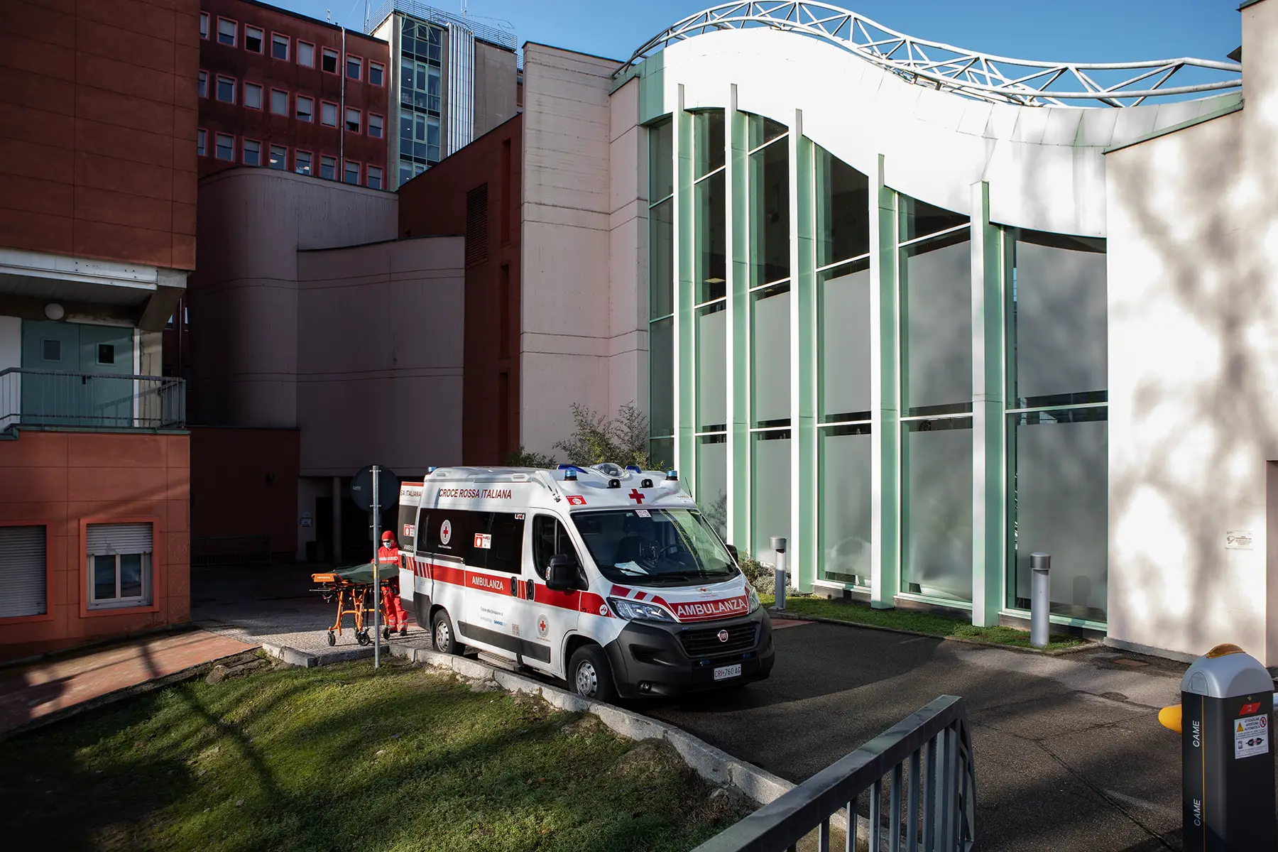 A hospital building with an ambulance parked outside