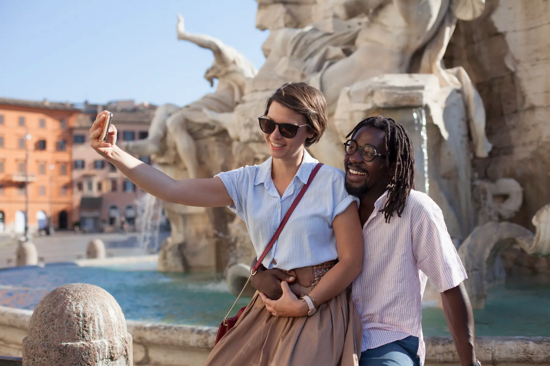 A couple enjoying a date and taking selfies at Piazza Navona in Rome