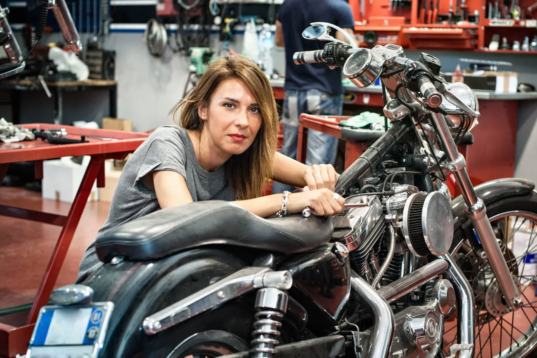 Portrait of female mechanic in motorcycle workshop