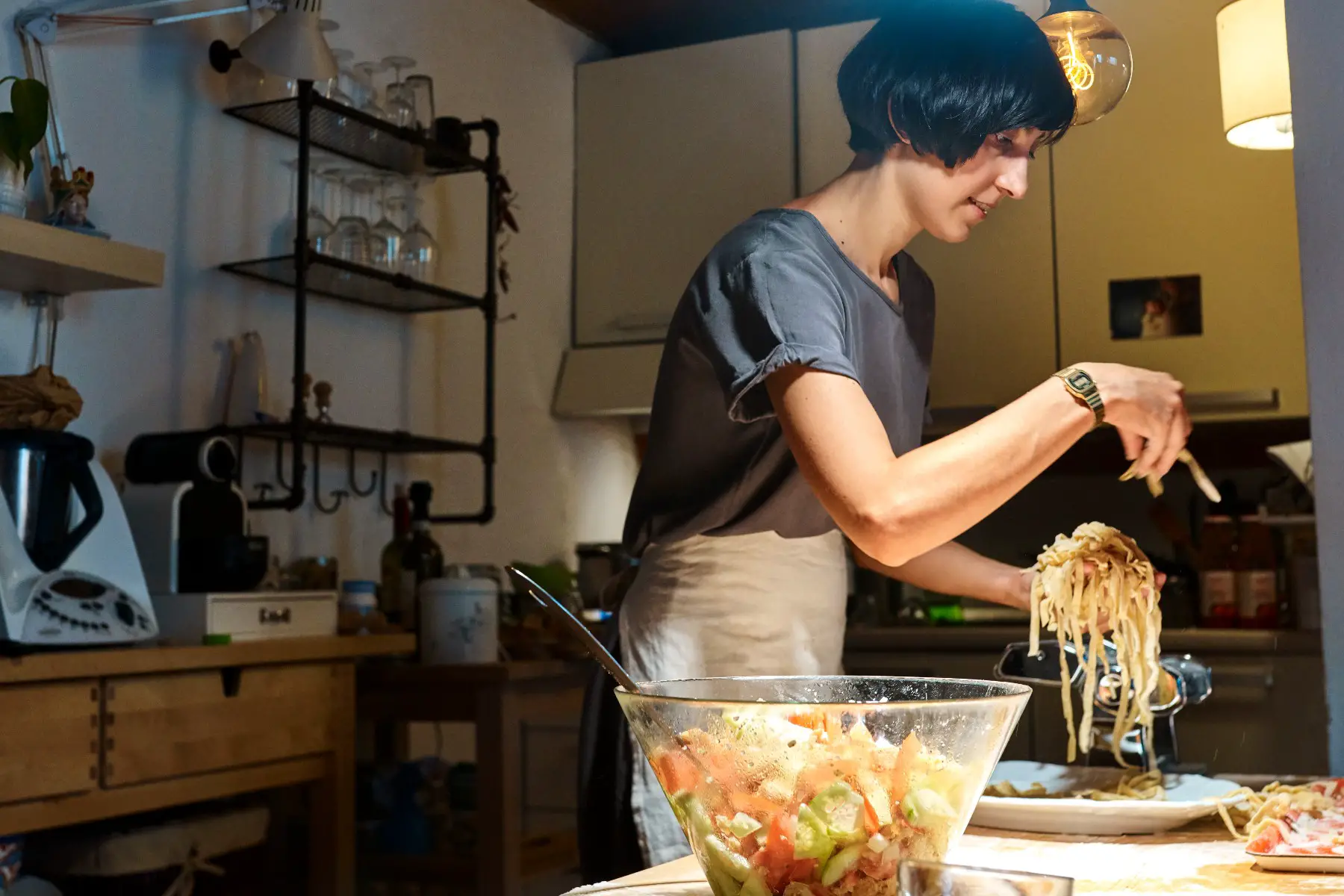 A woman preparing freshly made pasta at home
