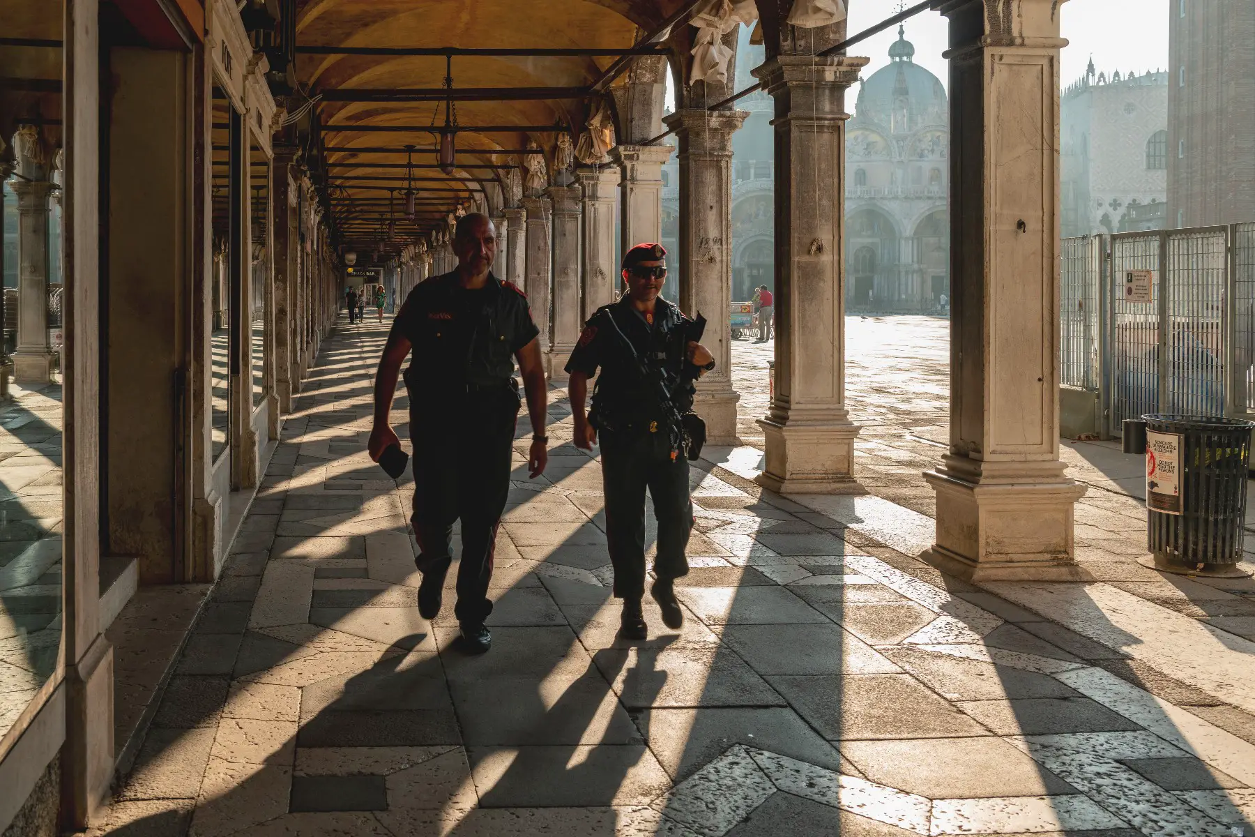Two police officers walking at the Piazza San Marco (St. Mark's Square) in Venice, Italy.