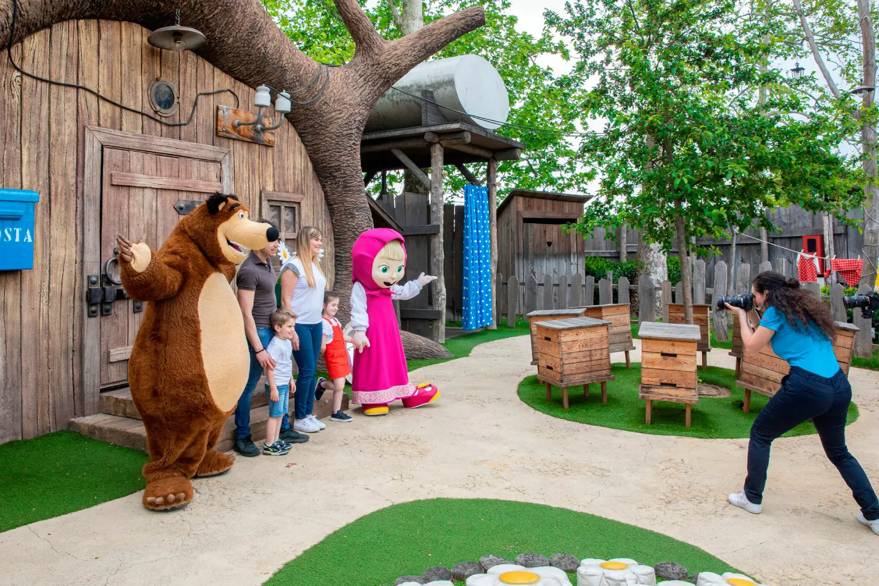 A family with children having their photo taken with Masha and the Bear at Leolandia Resort in Italy
