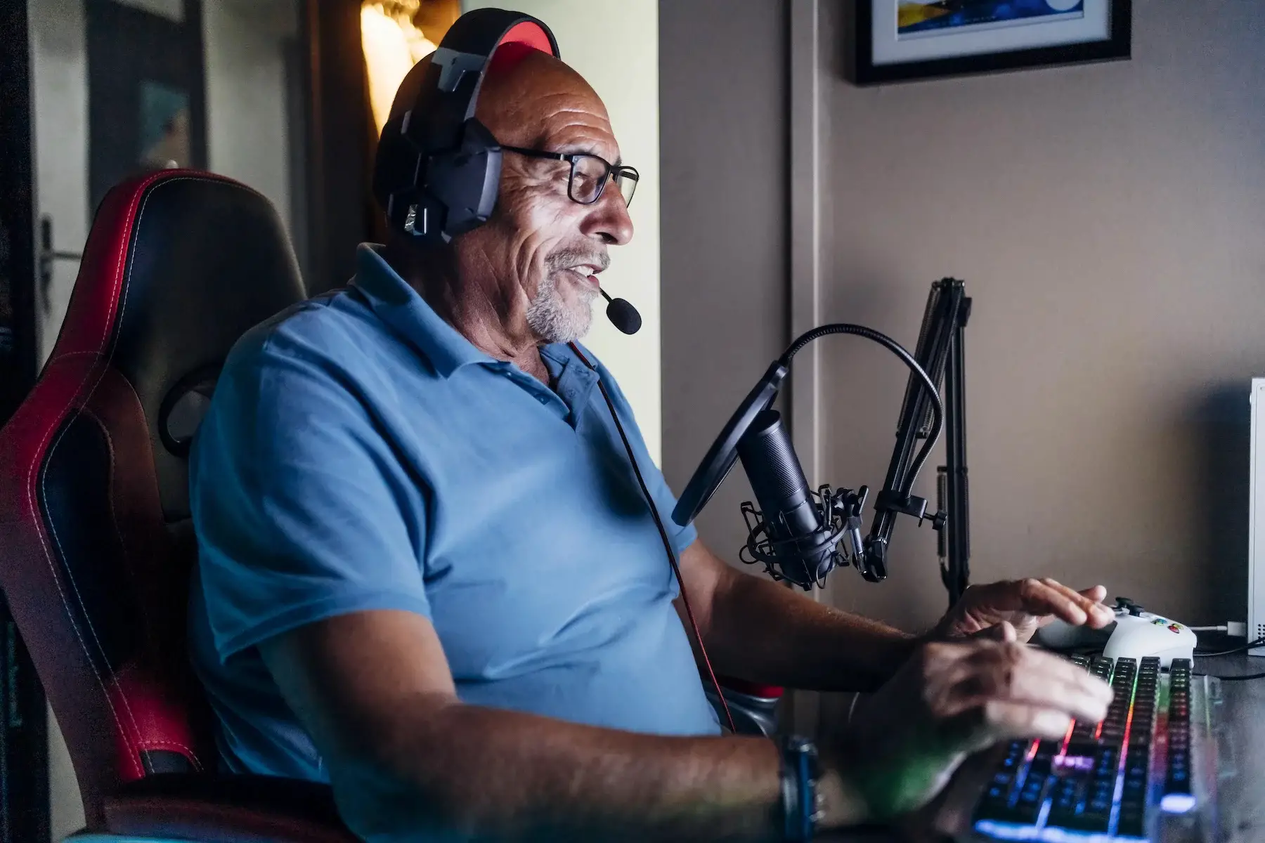 A middle-aged man sits at his gaming computer
