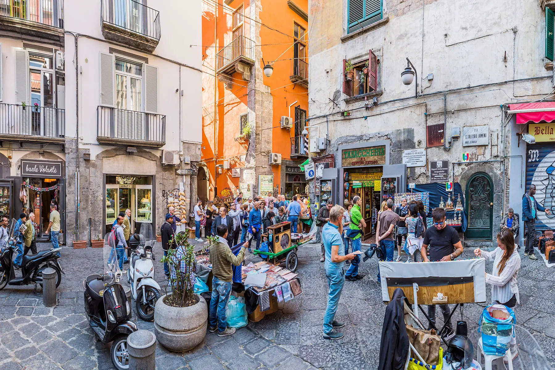 Typical street life at the corner between Via San Gregorio Armeno and Via San Biagio dei Librai, with people
