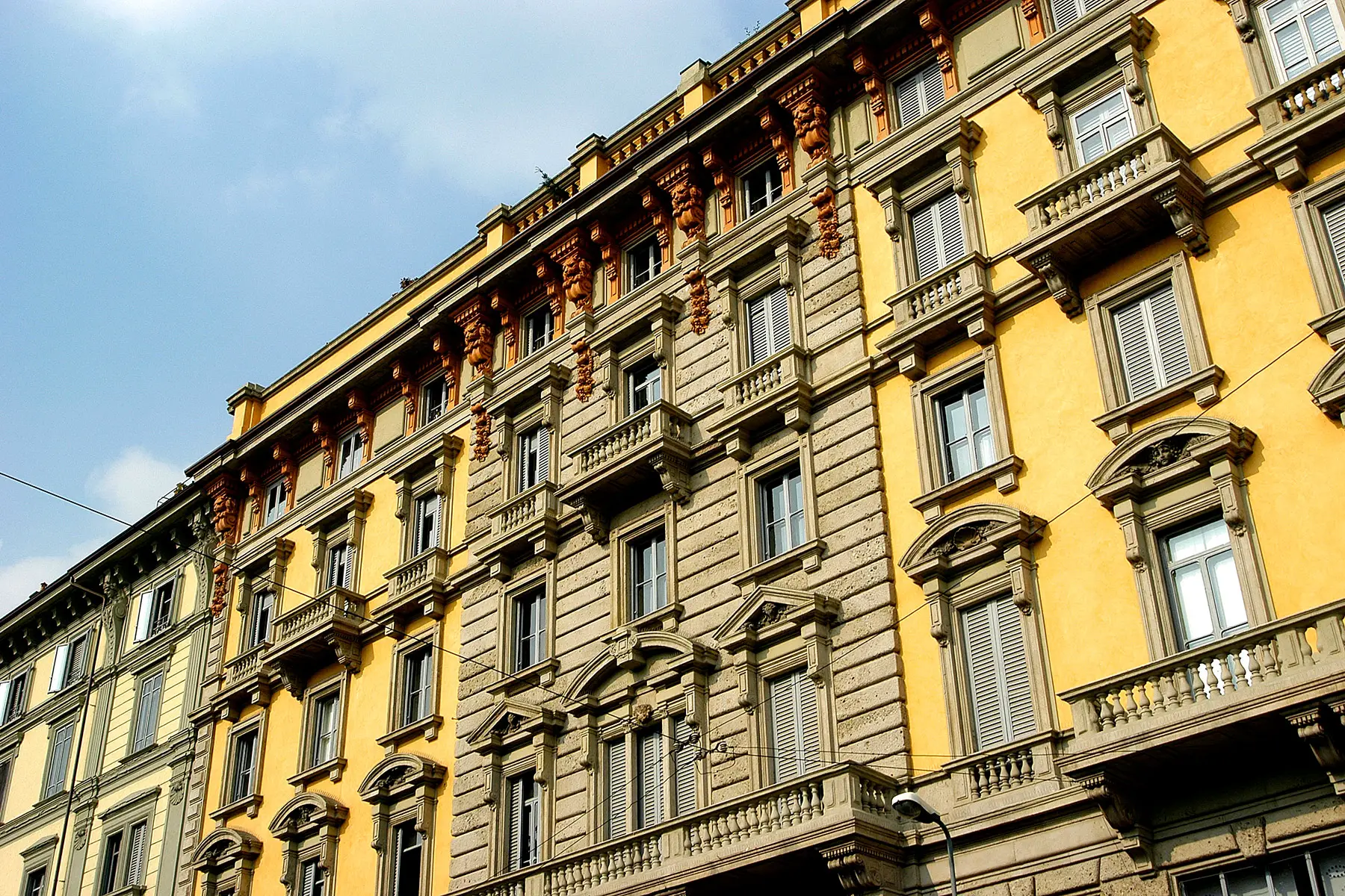 Old-fashioned yellow and beige apartment buildings in Porta Venezia, Milan