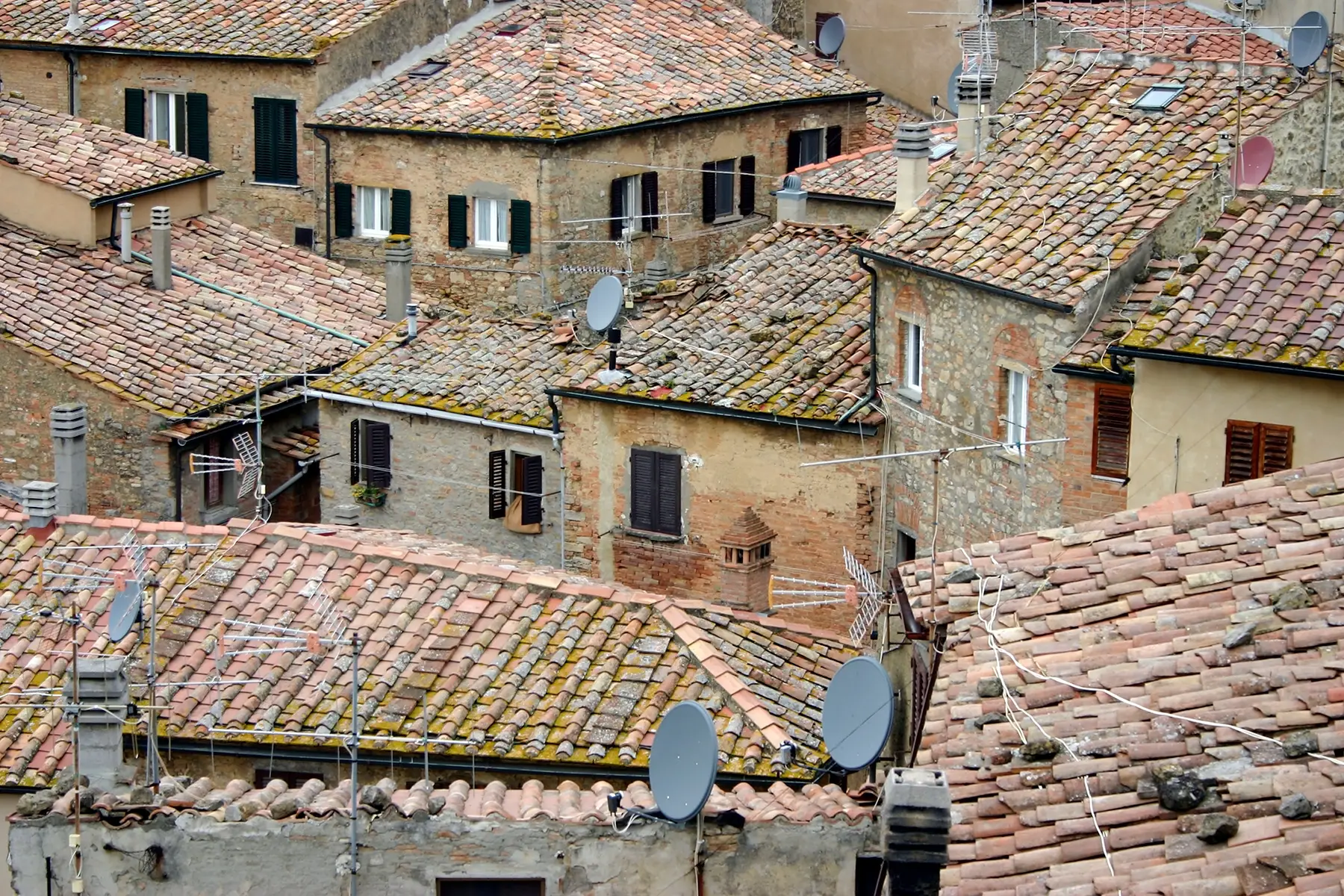 Teracotta rooftops with satellite dishes