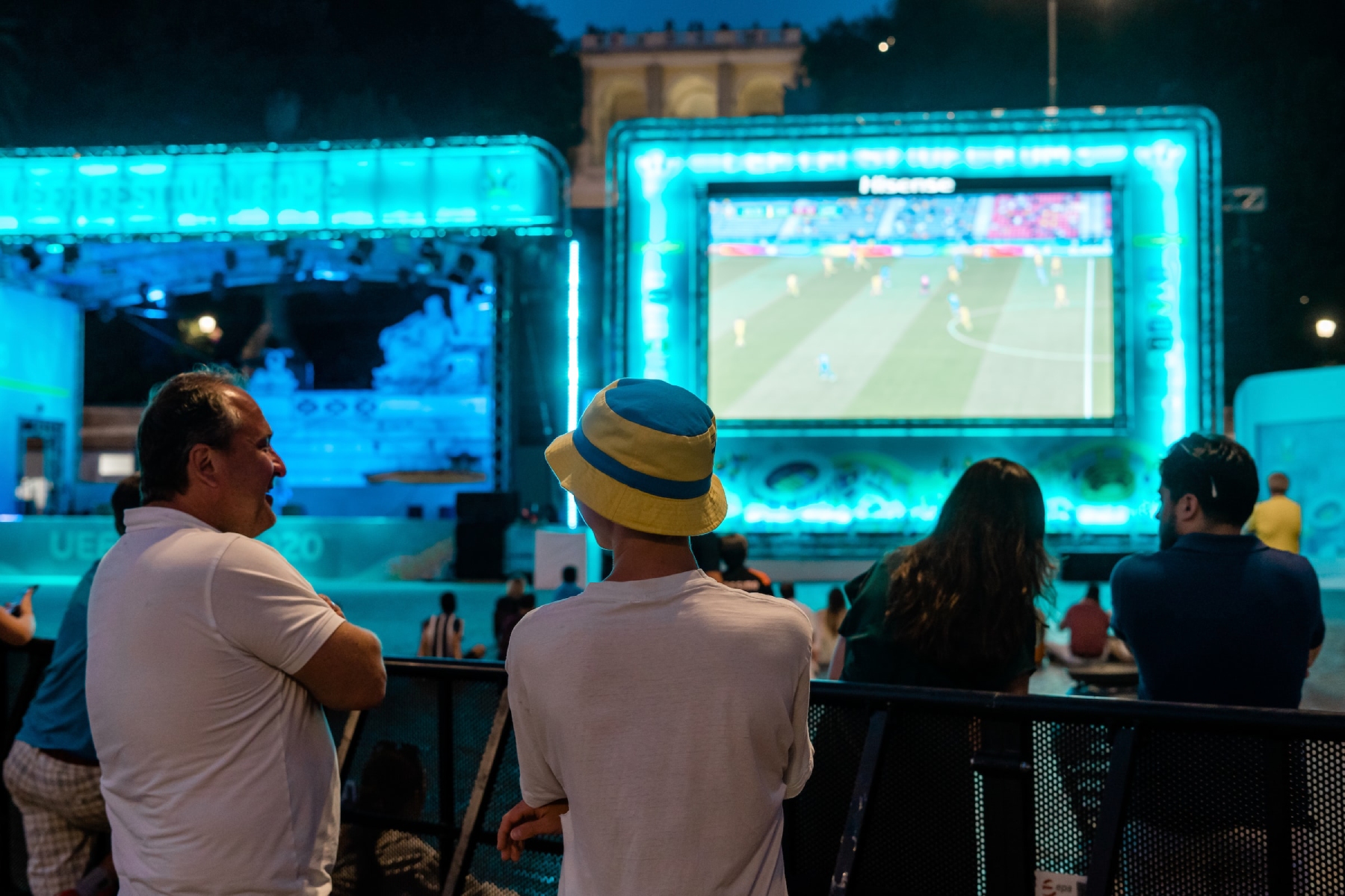 Spectators watch football (soccer) on an outdoor screen in Rome