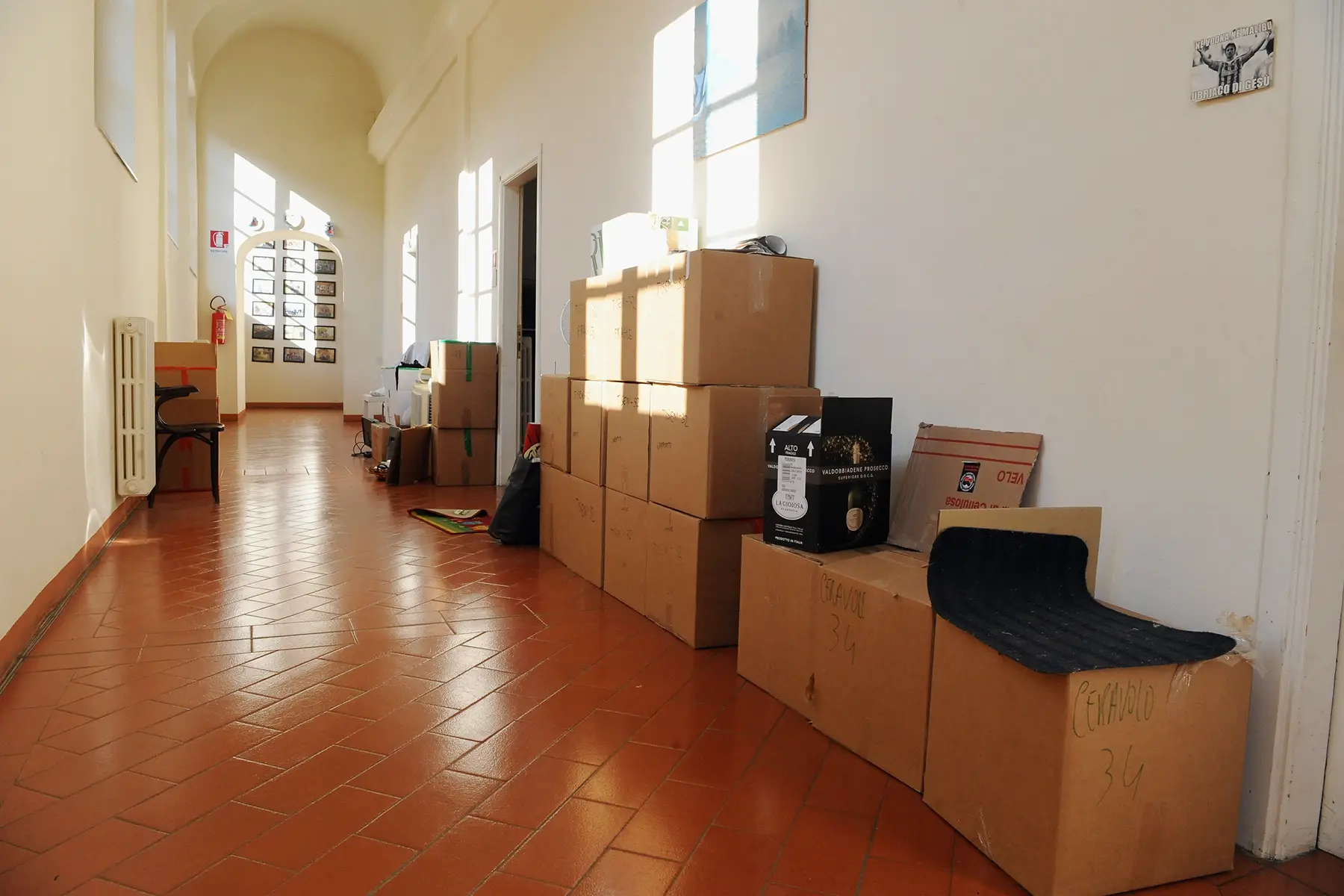 Empty hallway of a student accommodation building with moving boxes in Pisa, Italy