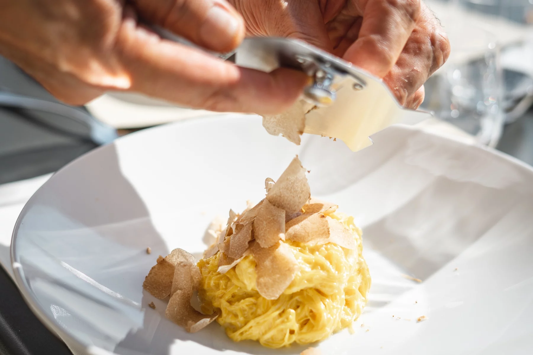 Putting white truffel shaving on tajarin pasta