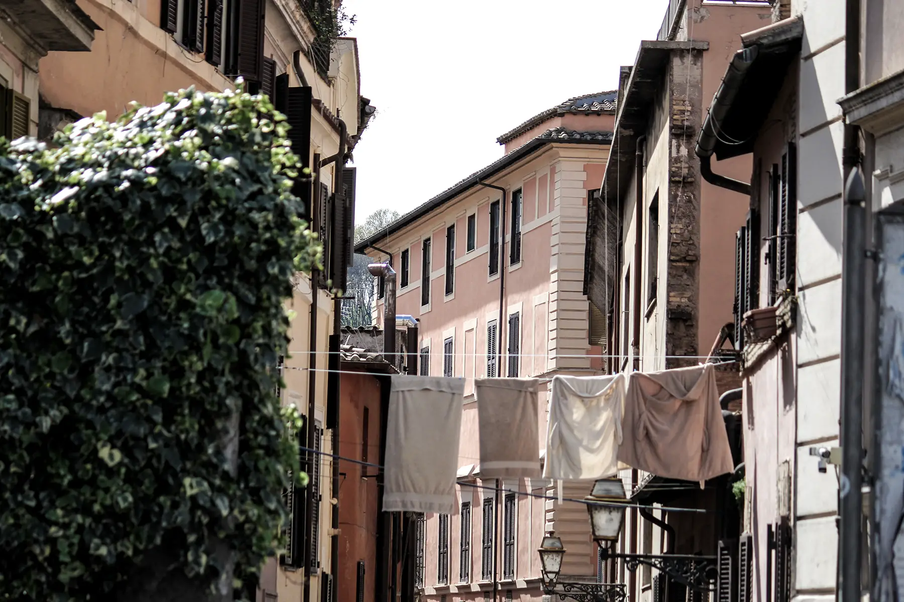 Washing hanging between buildings on a street in Trastevere, Rome