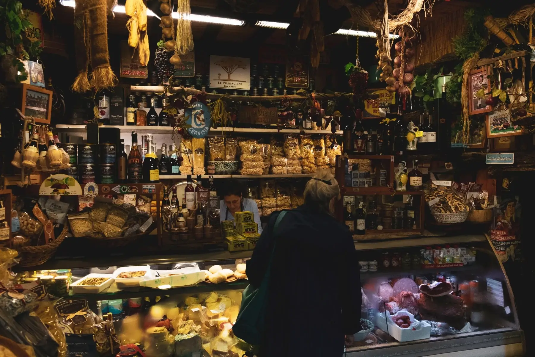 Woman buying food at a deli market in Florence