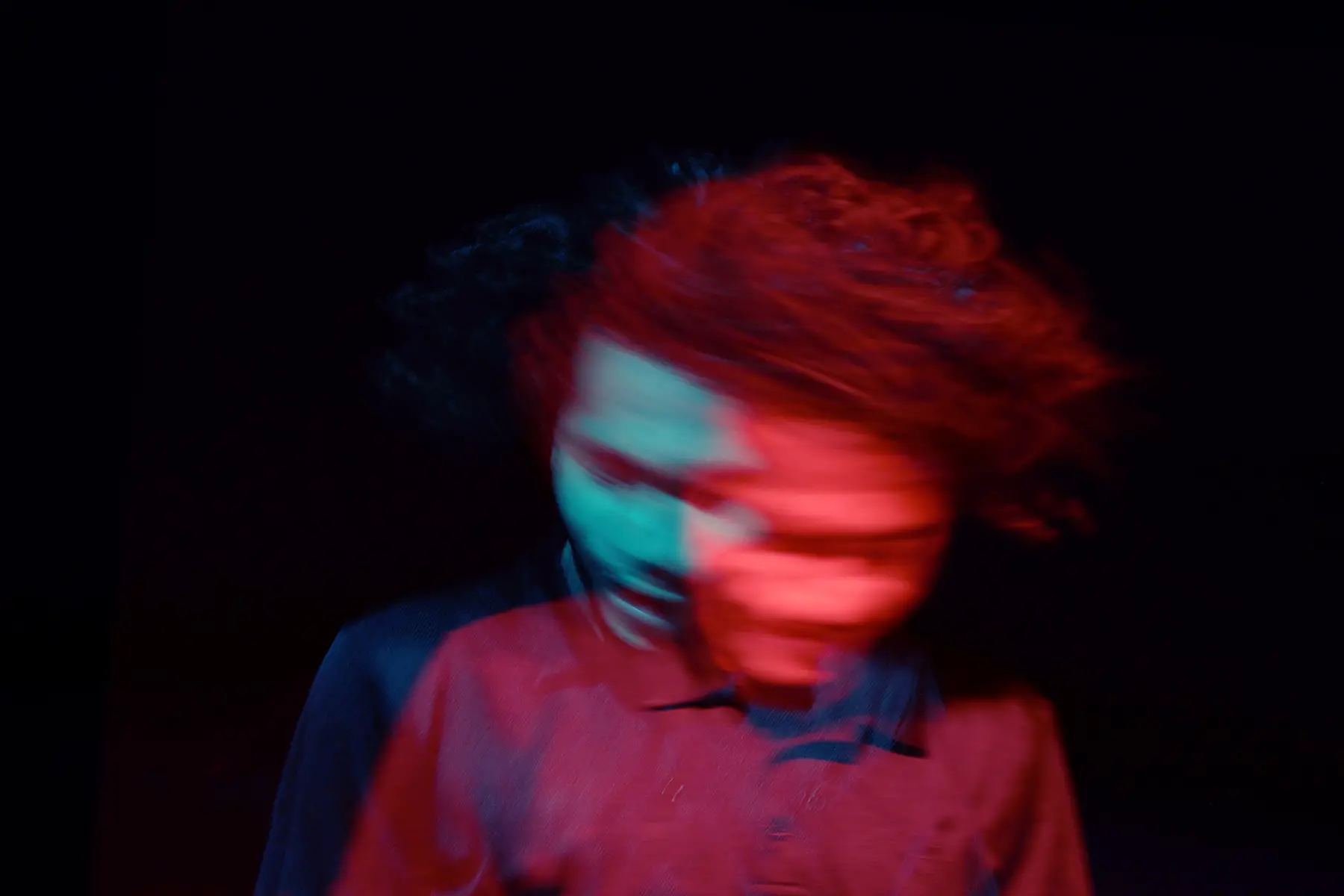Double exposure of the head and shoulders of a person - blurry movement - black background