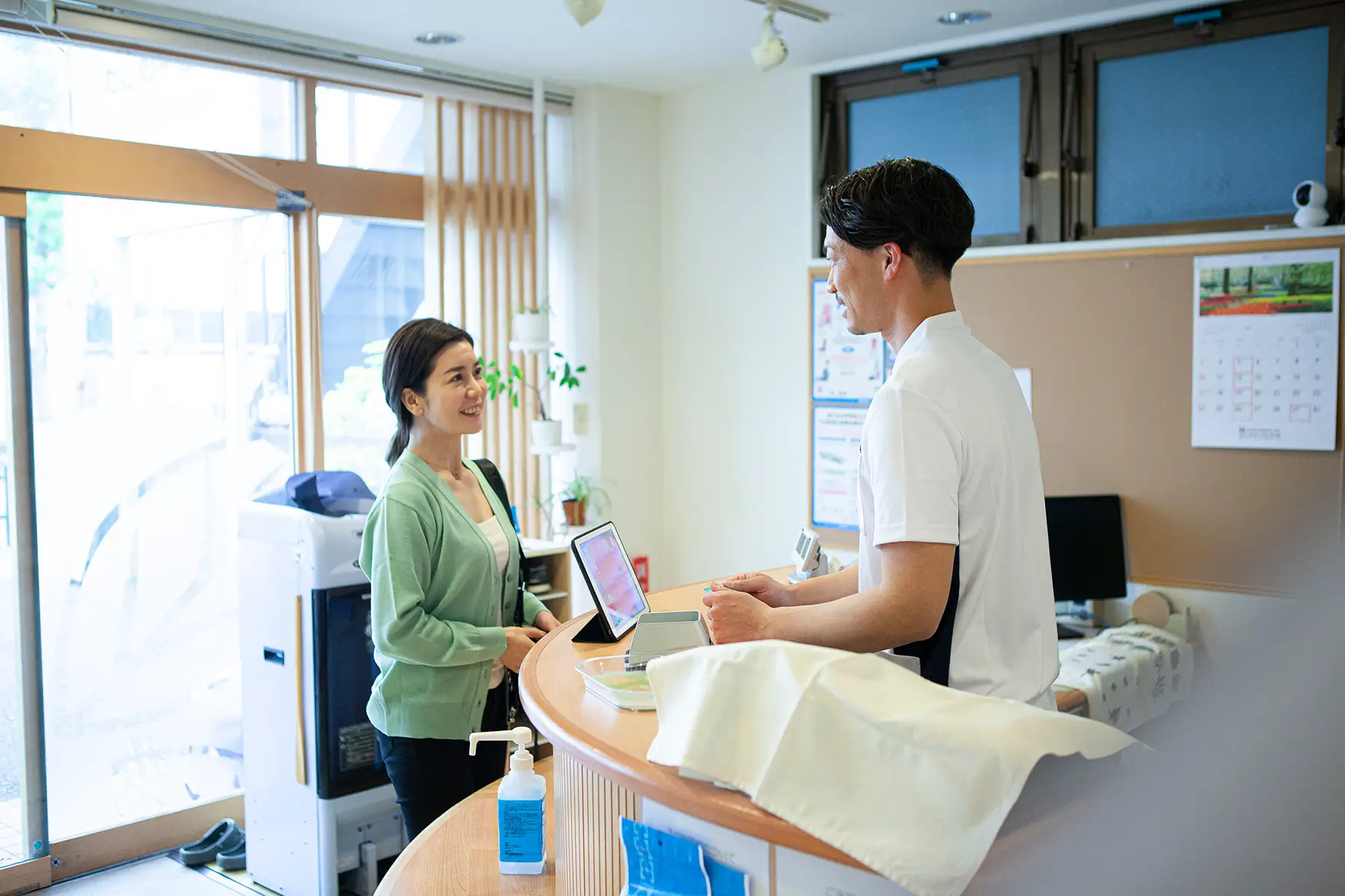 A woman paying for dental treatment at reception