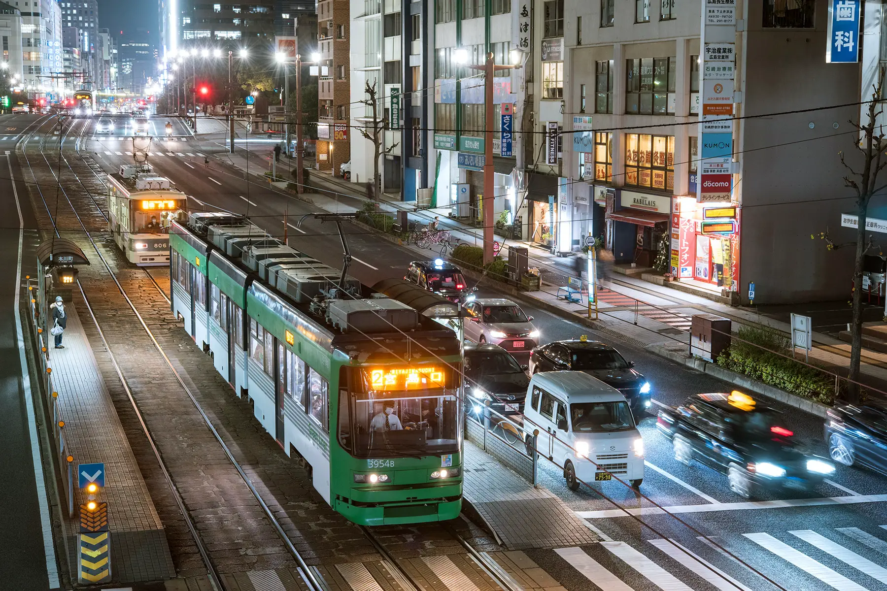 A tram and cars on a street in Hiroshima