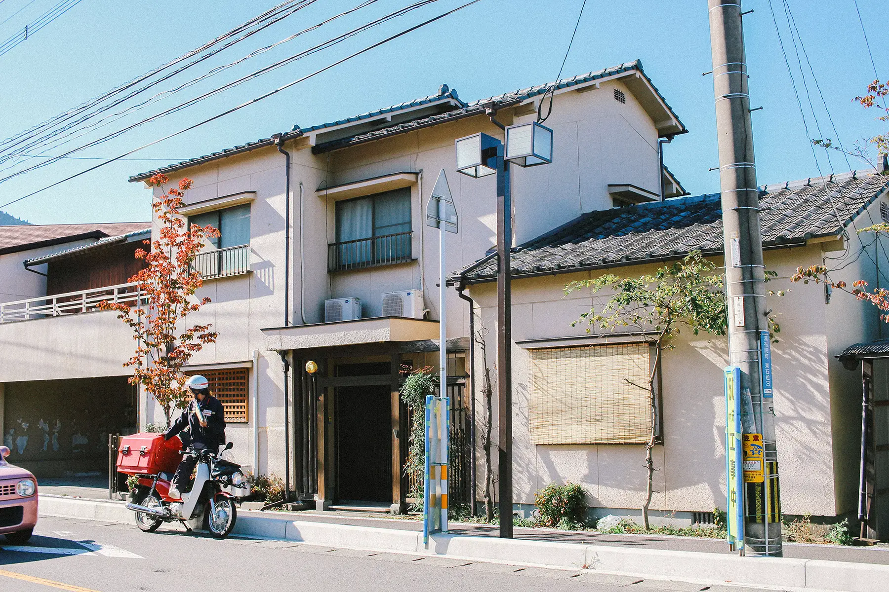 A house with a person on a motorbike in front of it
