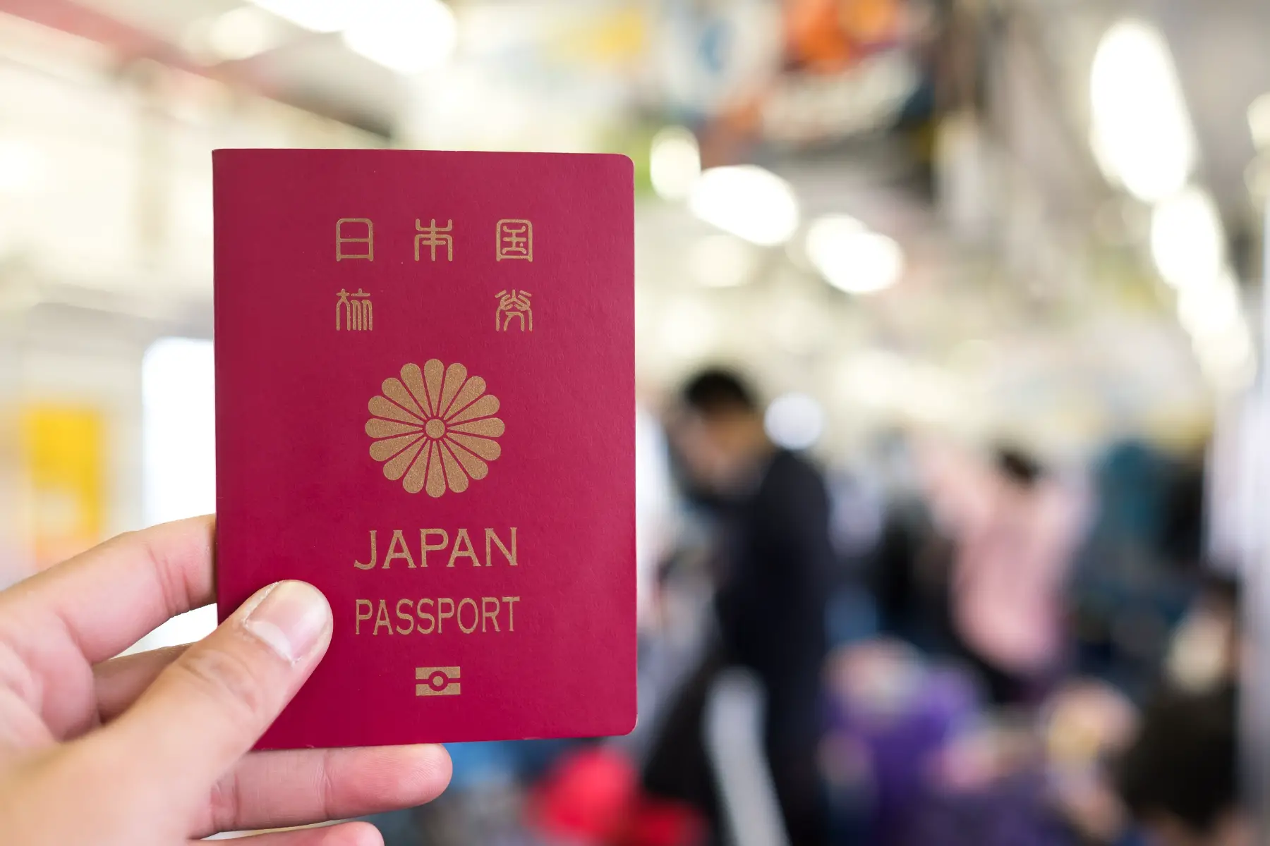 Person holding Japanese passport on train