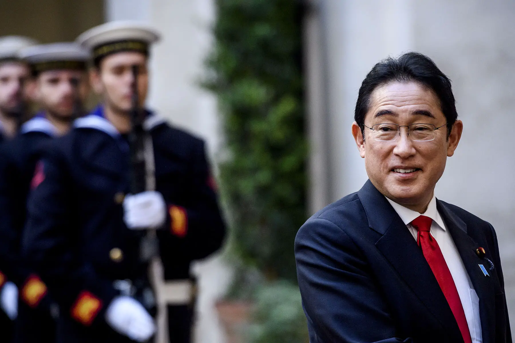 Smiling Prime Minister Minister Kishida Fumio during his 2023 visit to Rome, Italy. Roman Navy personnel in the background.