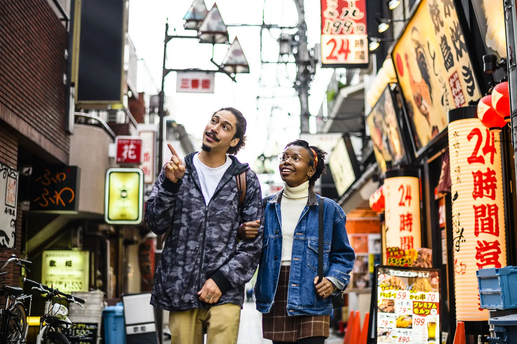Two tourists walking through Tokyo, Japan, pointing at stuff.