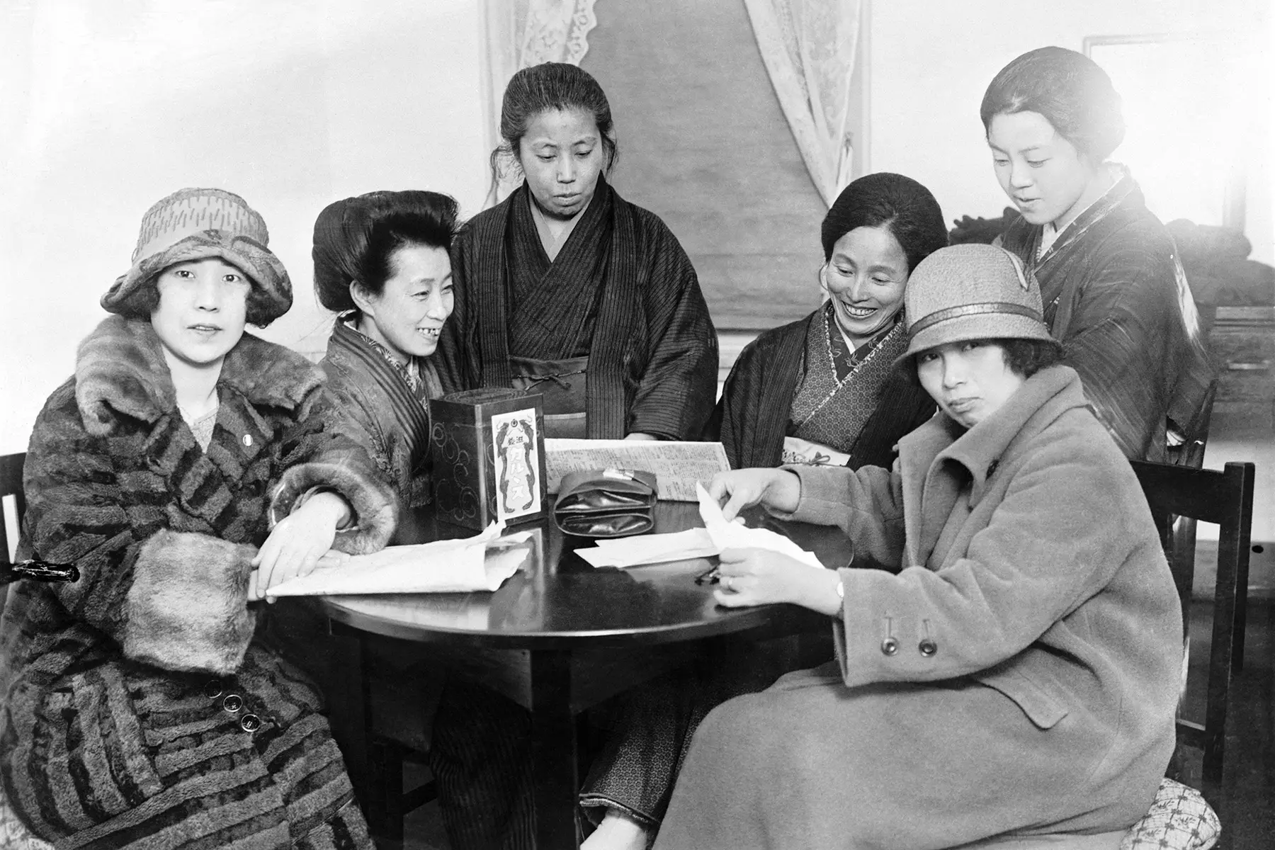 Black and white picture of Japanese Suffragettes sitting around a table in 1926