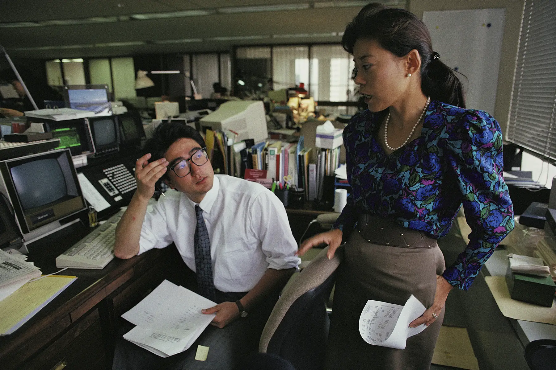 Junko Yoda, vice president at Goldman Sachs, standing by a male employee in her offices in 1989