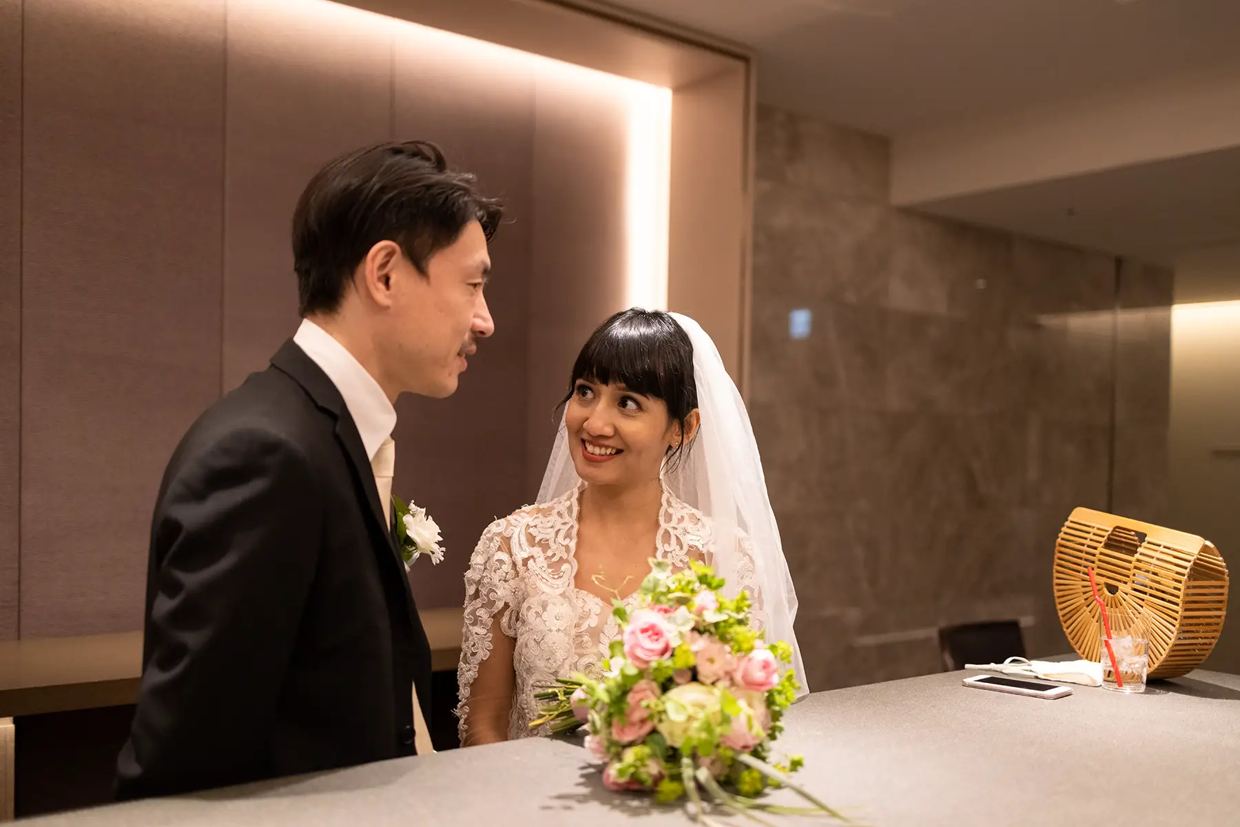A couple smile at each other during a wedding ceremony