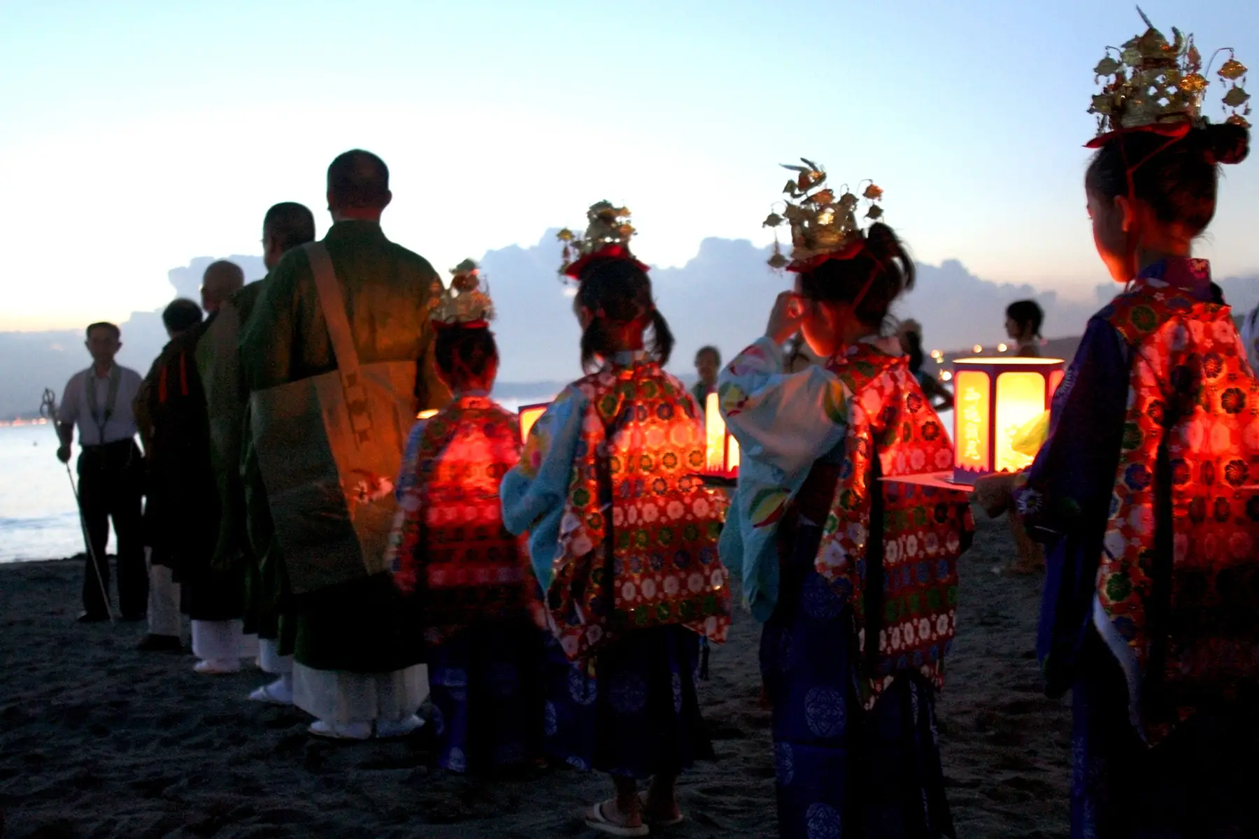 A group of adults and children - in traditional dress - celebrating the Obon festival, carrying lanterns, in Hayama, Kanagawa, Japan 