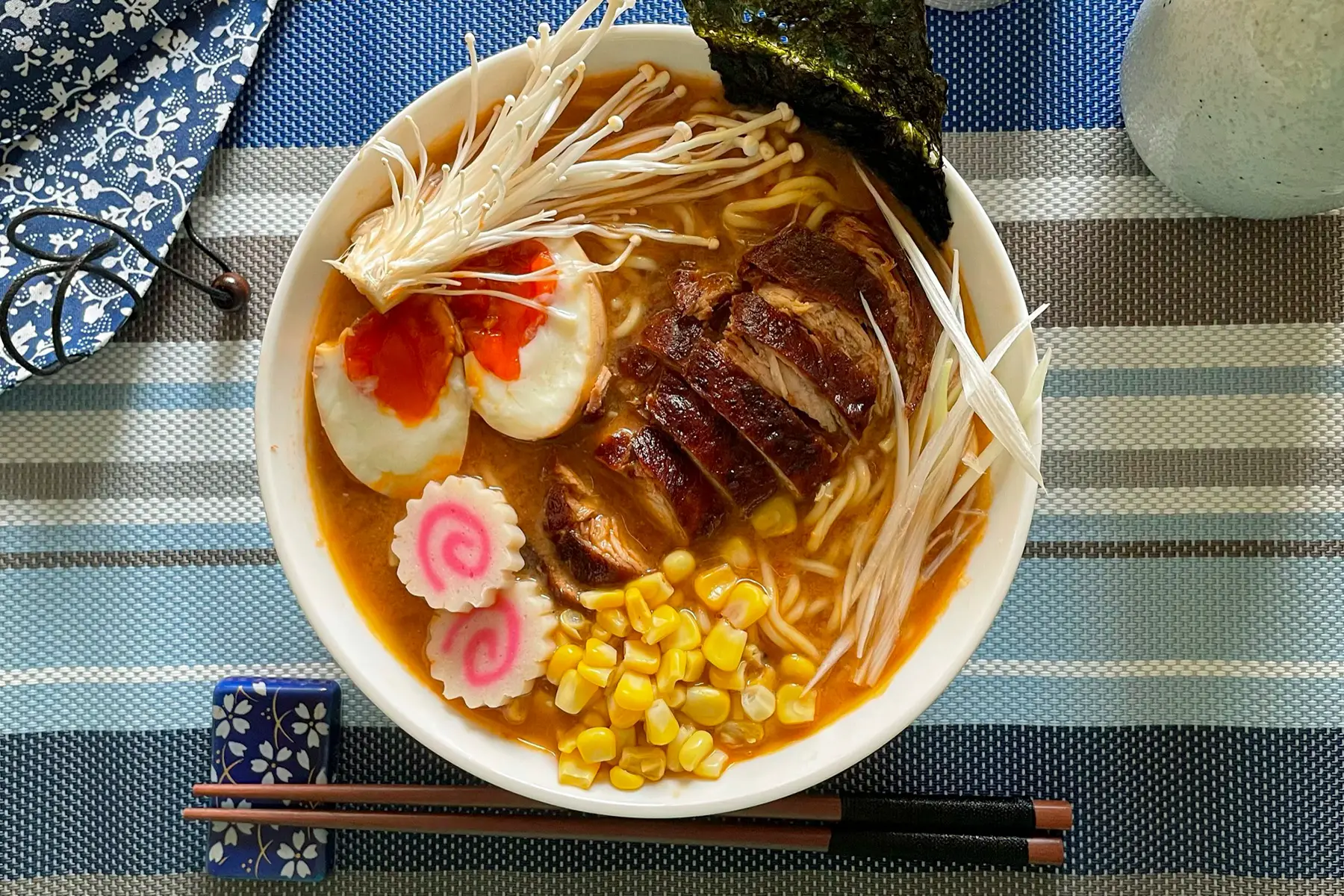 A bowl of ramen - a soup with noodles, vegetables, chicken, and egg