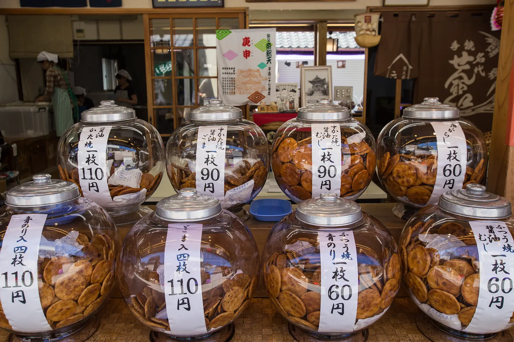 Large jars of senbei for sale. 
