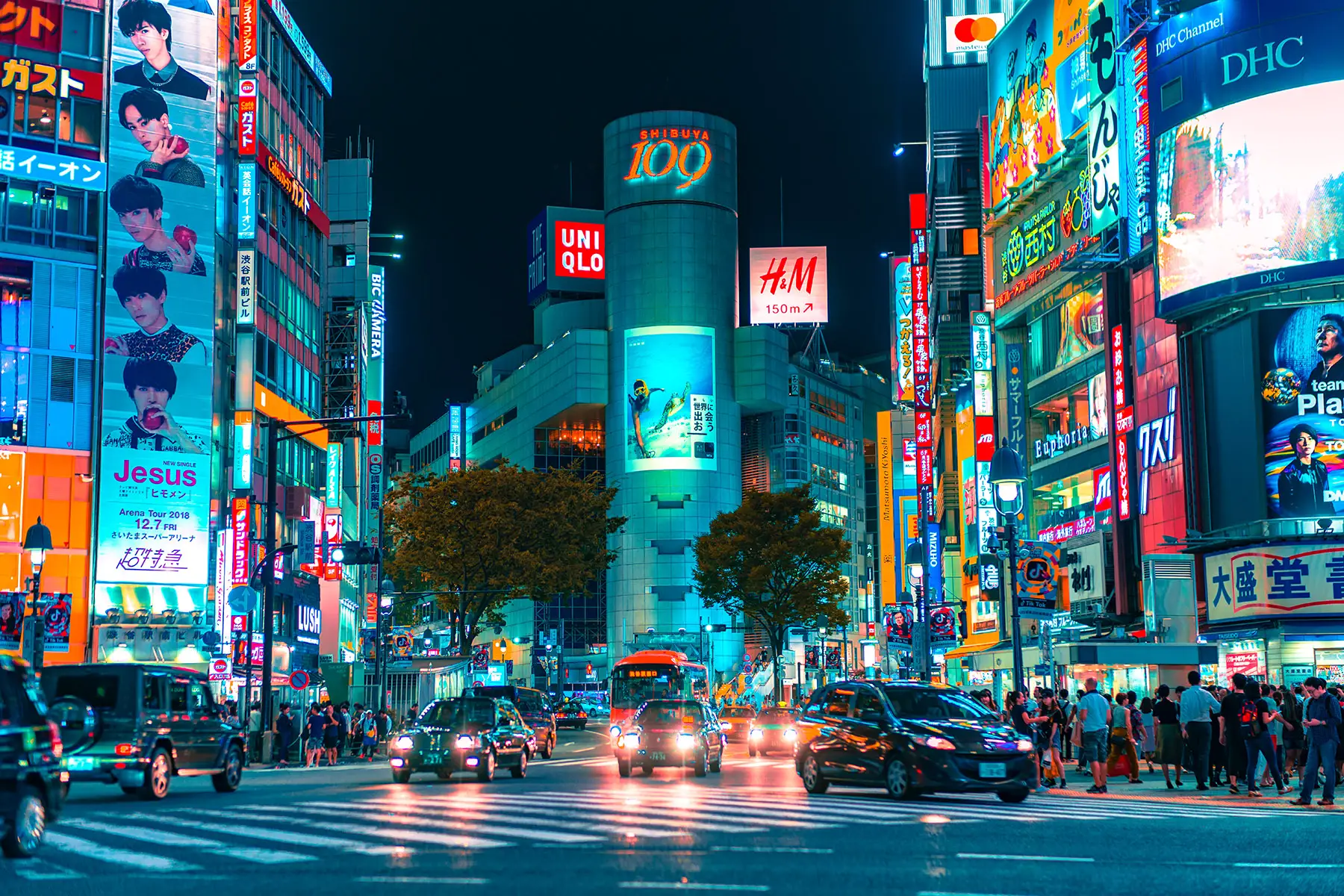A night street scene with cars in Shibuya, Japan