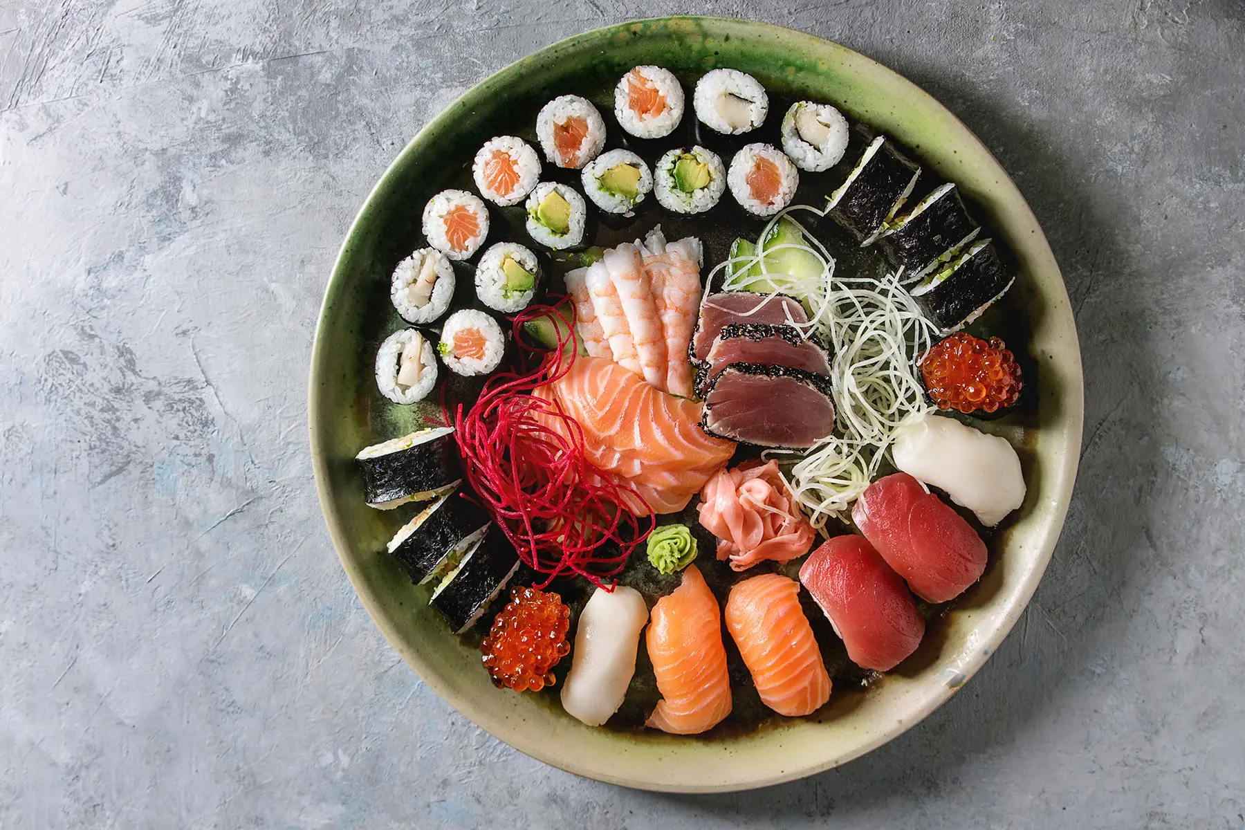 A bowl with colorful sushi and sashimi
