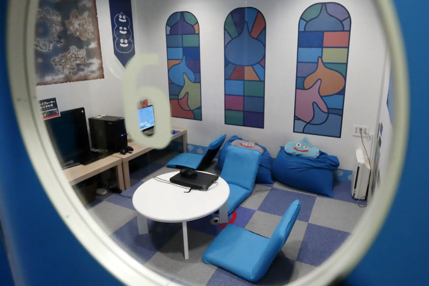 A rentable room designed for families at a Tokyo internet cafe, the room is bright blue with bean bag chairs and several computers