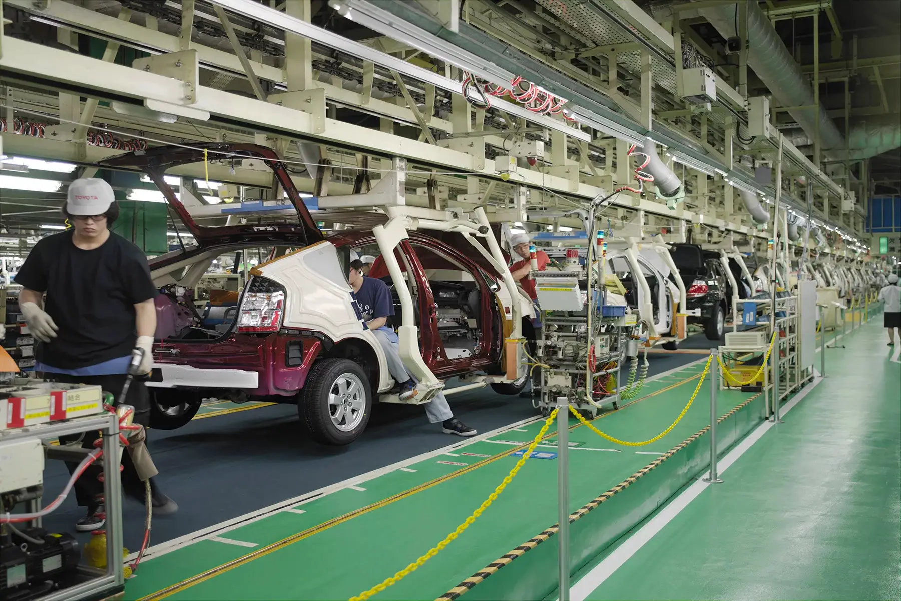 Workers assembling Toyota Prius cars in a factory in Japan