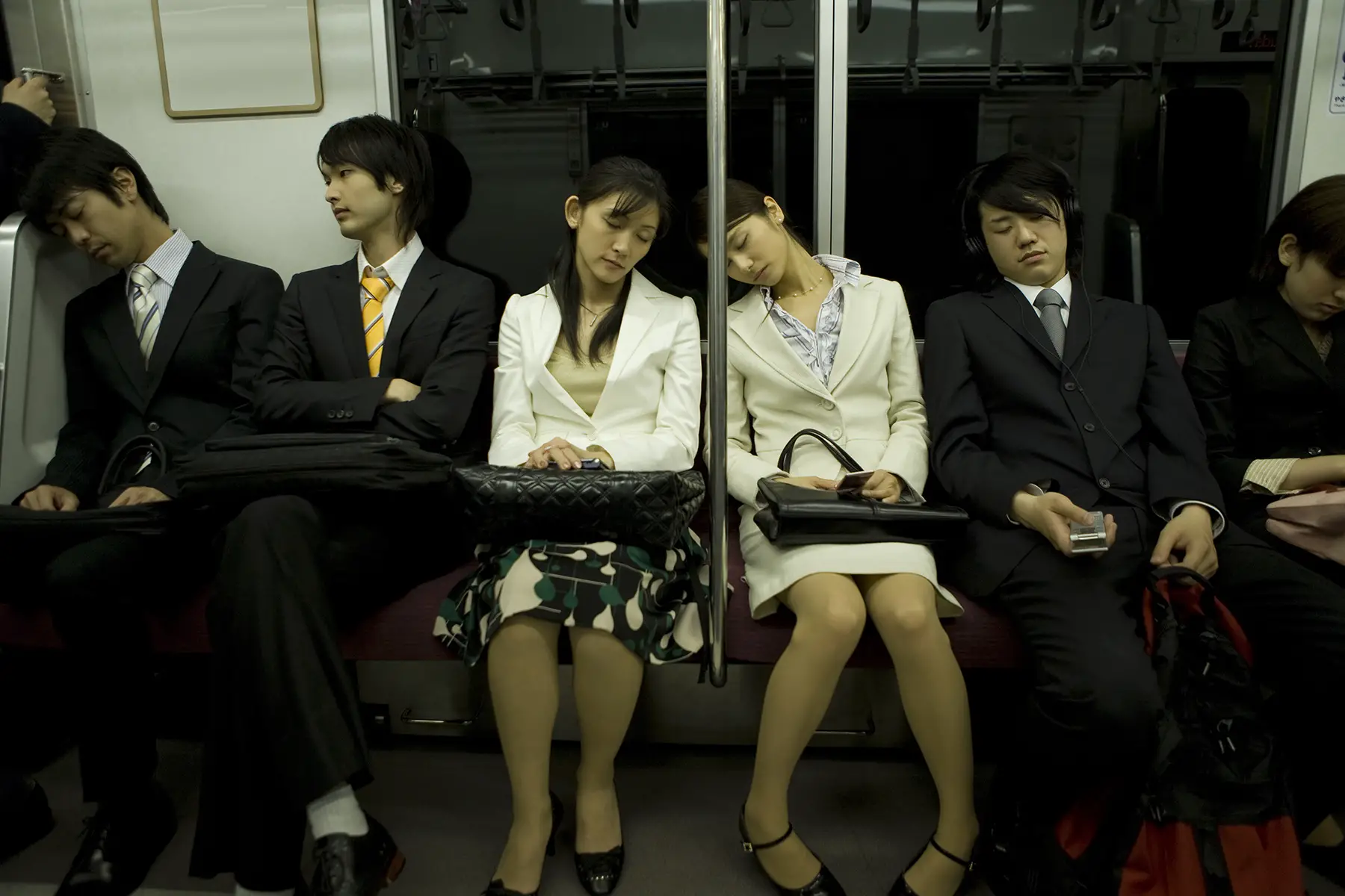 People commuting back from work sleeping on the train