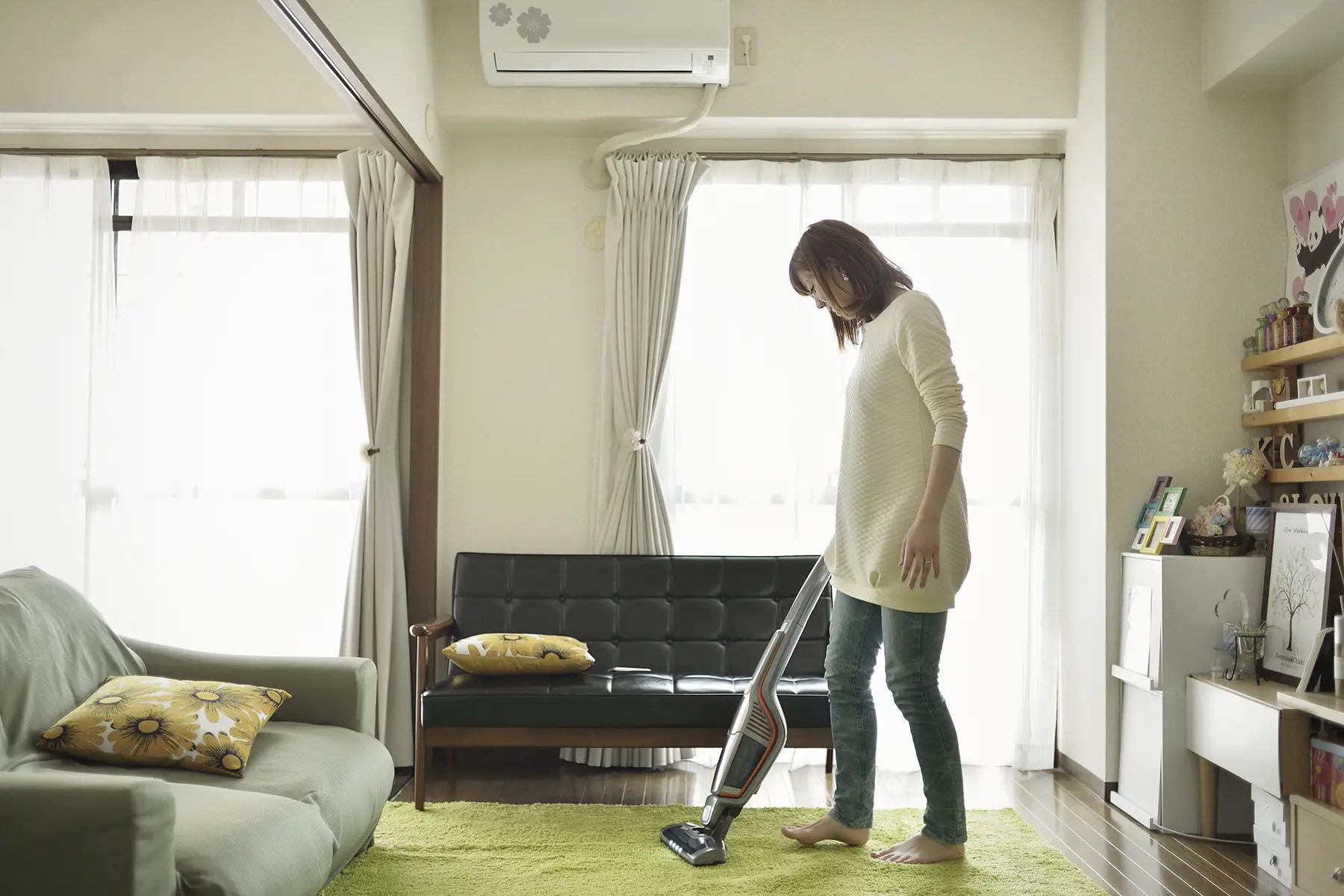 Woman vacuuming her apartment