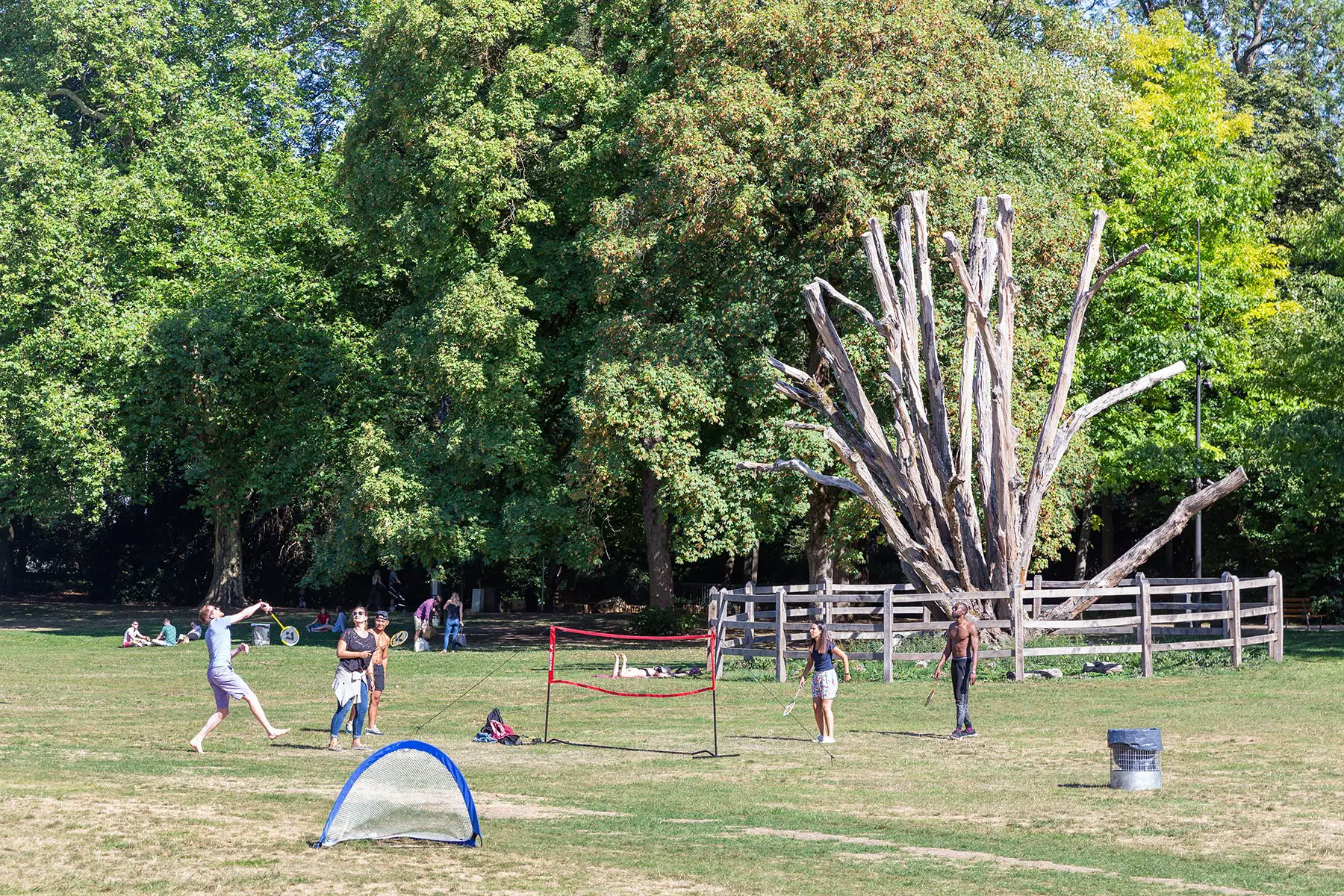 Young people playing badminton in a park