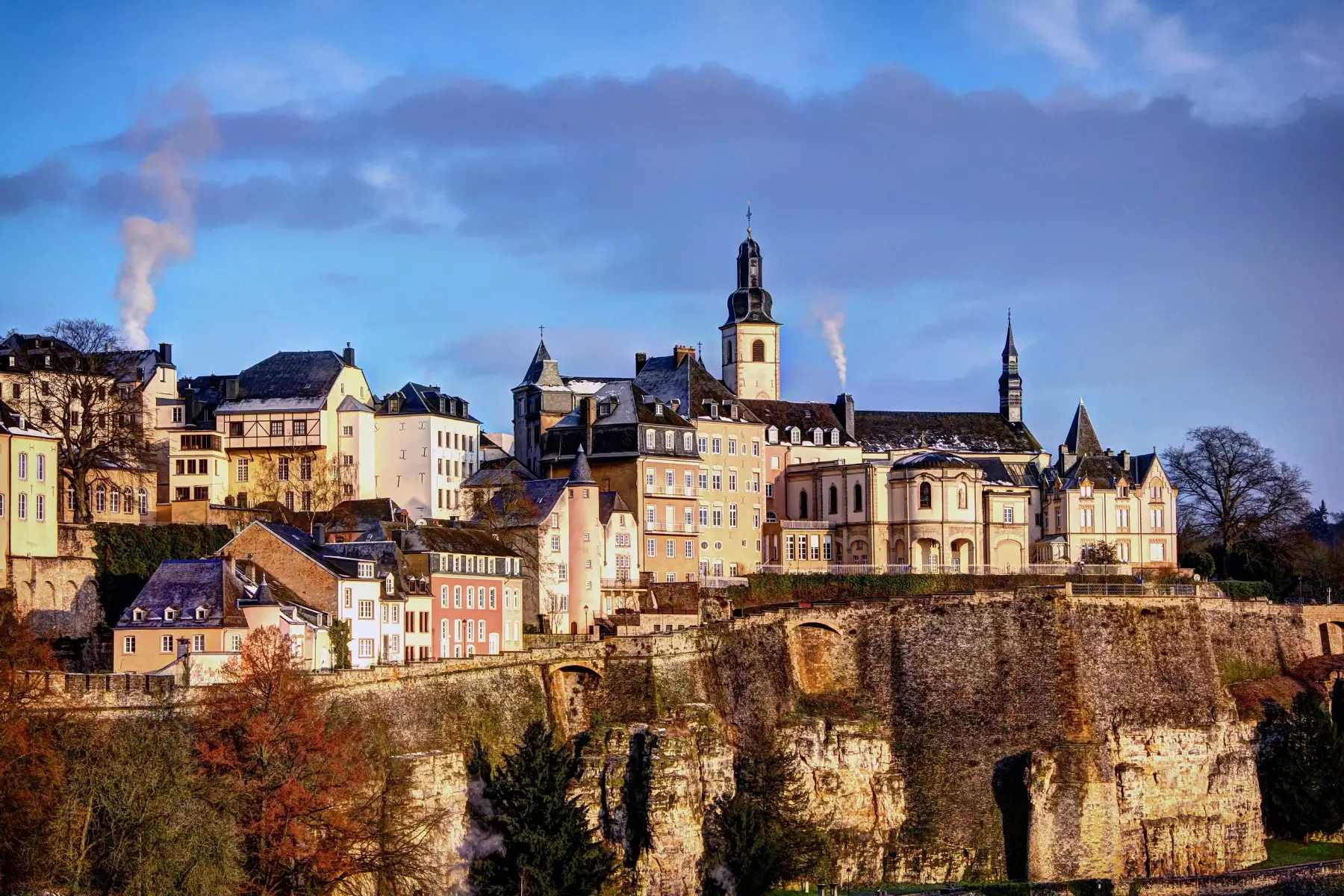 The Luxembourg City skyline with rooftops and St Michael church in the background