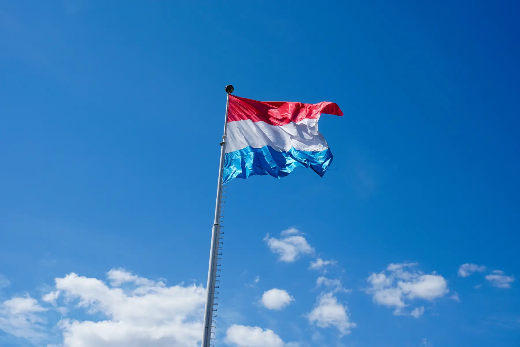 Luxembourg flag flying on mast