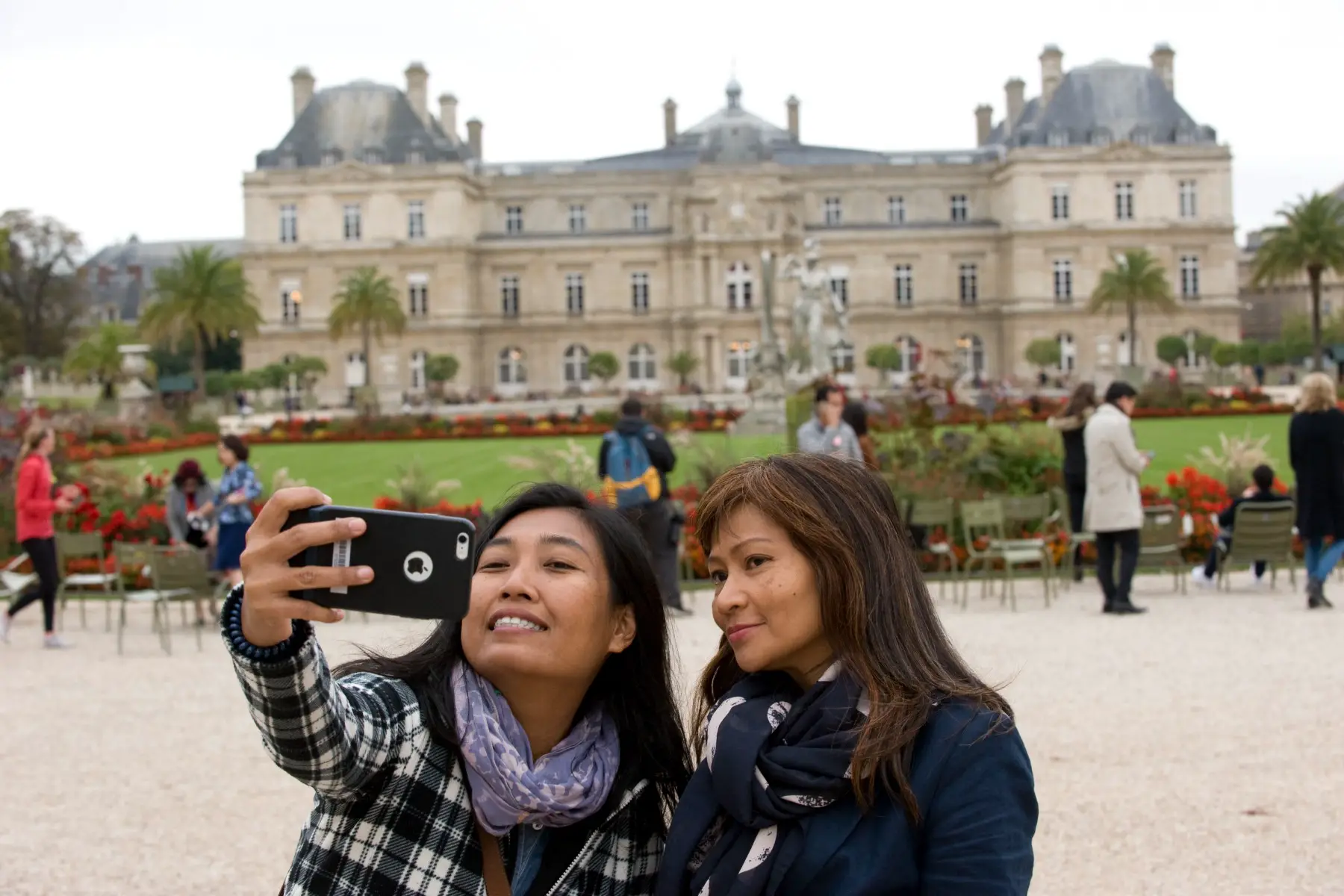 Woman and her mother taking a selfie at the Luxembourg Gardens in Paris, France.