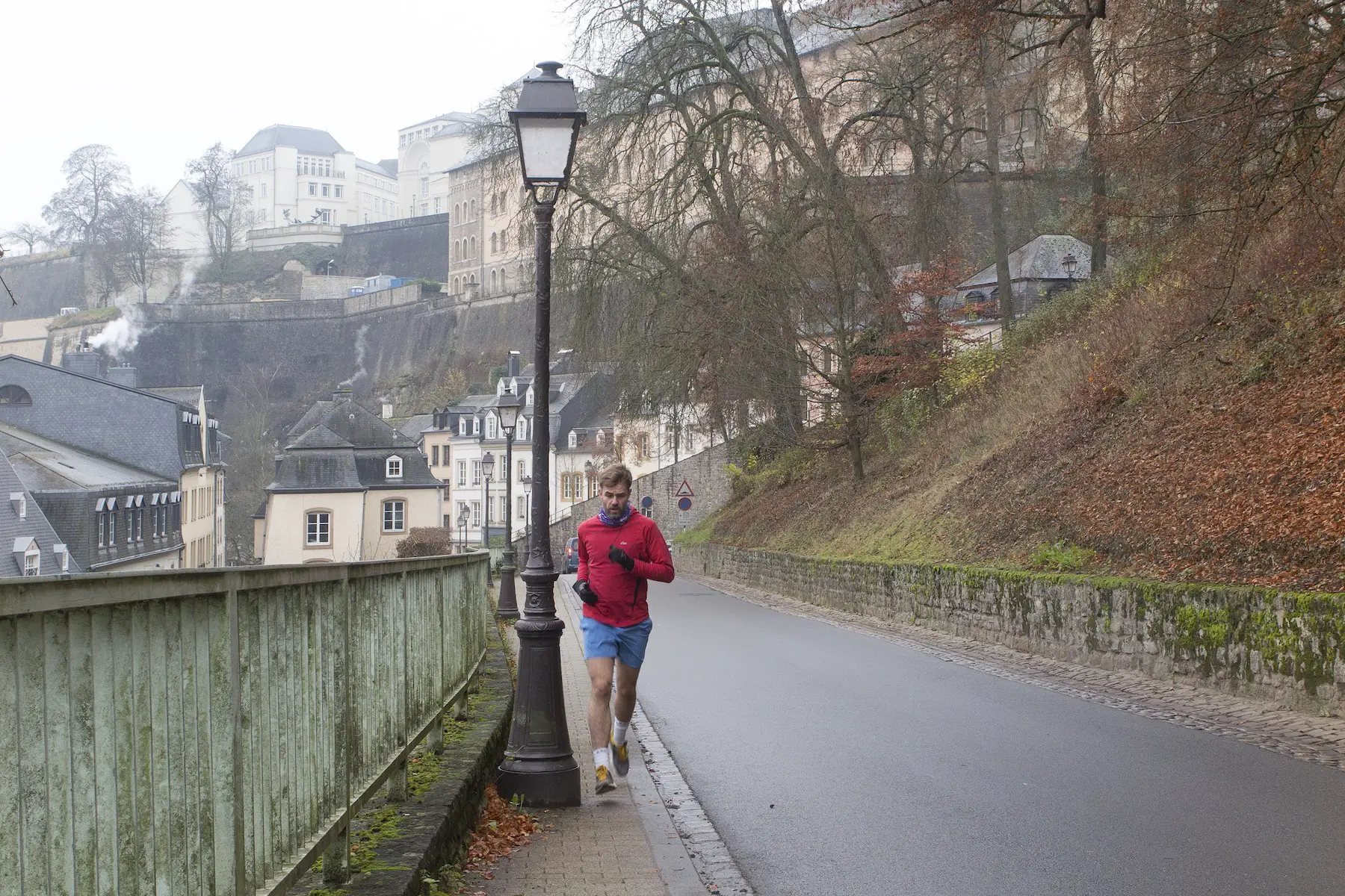 A jogger runs along Chemin de la Corniche in Luxembourg City in the early hours of a winter morning