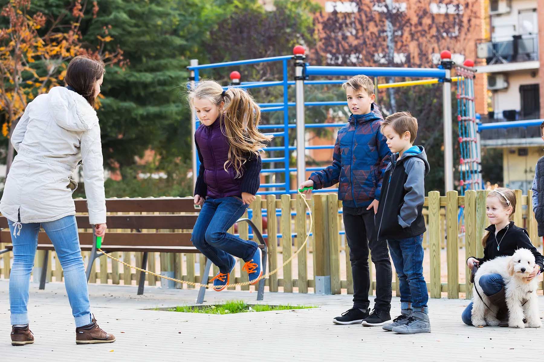 Group of children jumping rope on a playground in the Netherlands