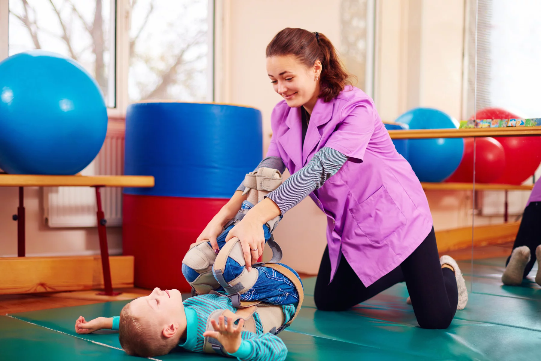 Child receiving physiotherapy from trained professional
