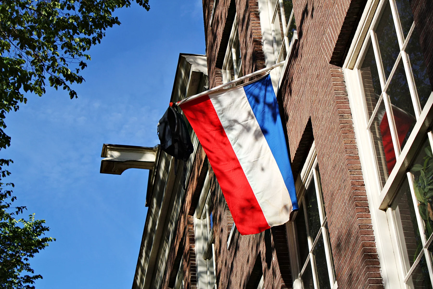 Students typically hang their backpack with a Dutch flag after completing their studies