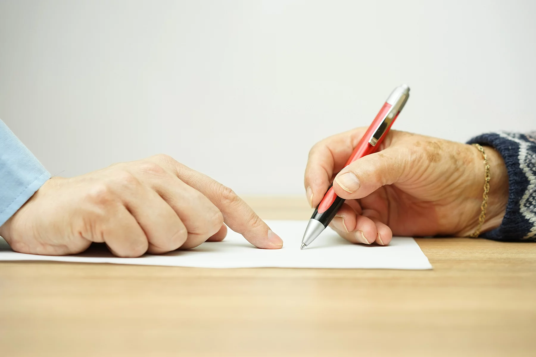 Elderly woman signing contract