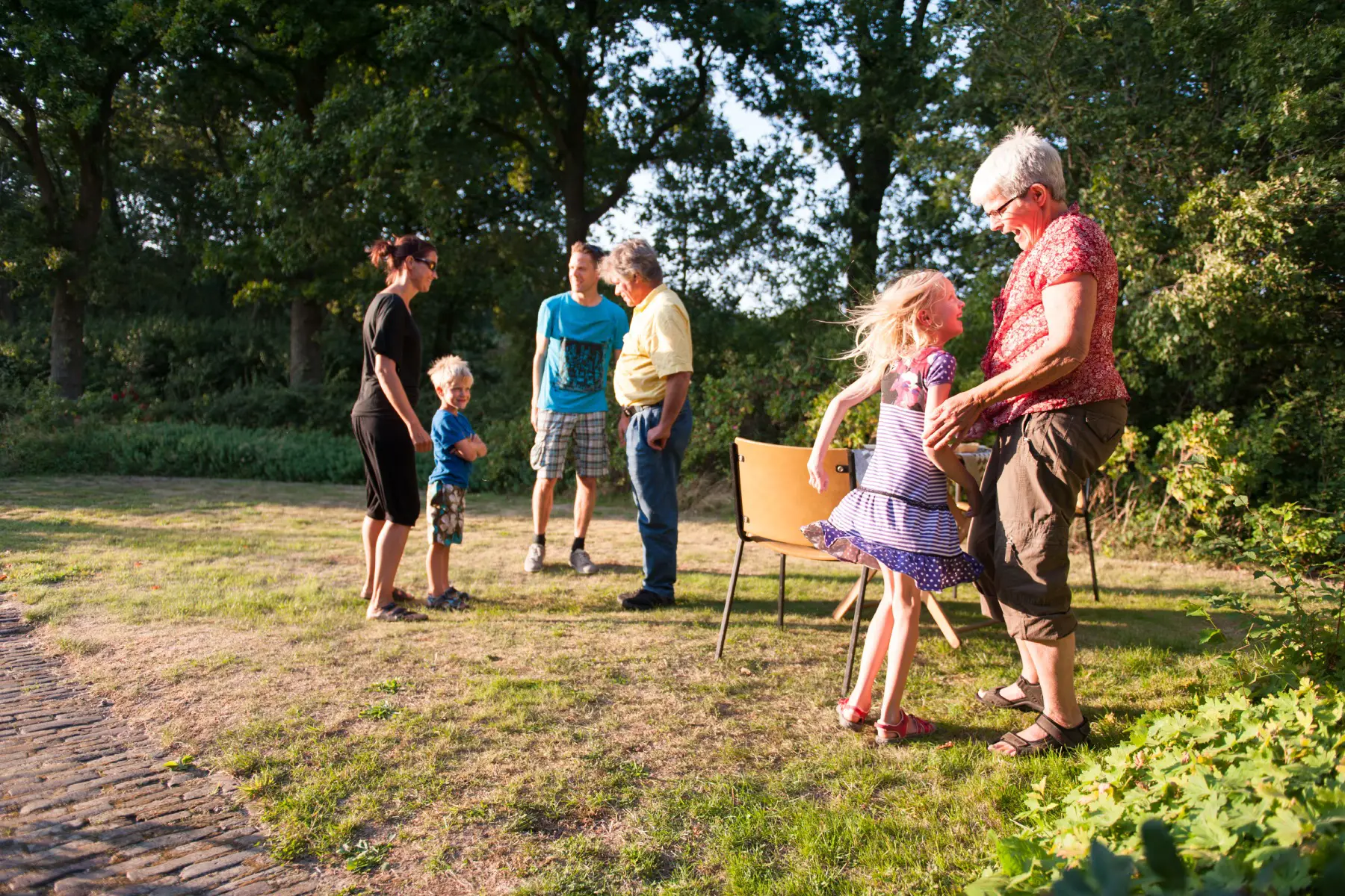 Grandparents and grandchildren reuniting for picnic in park